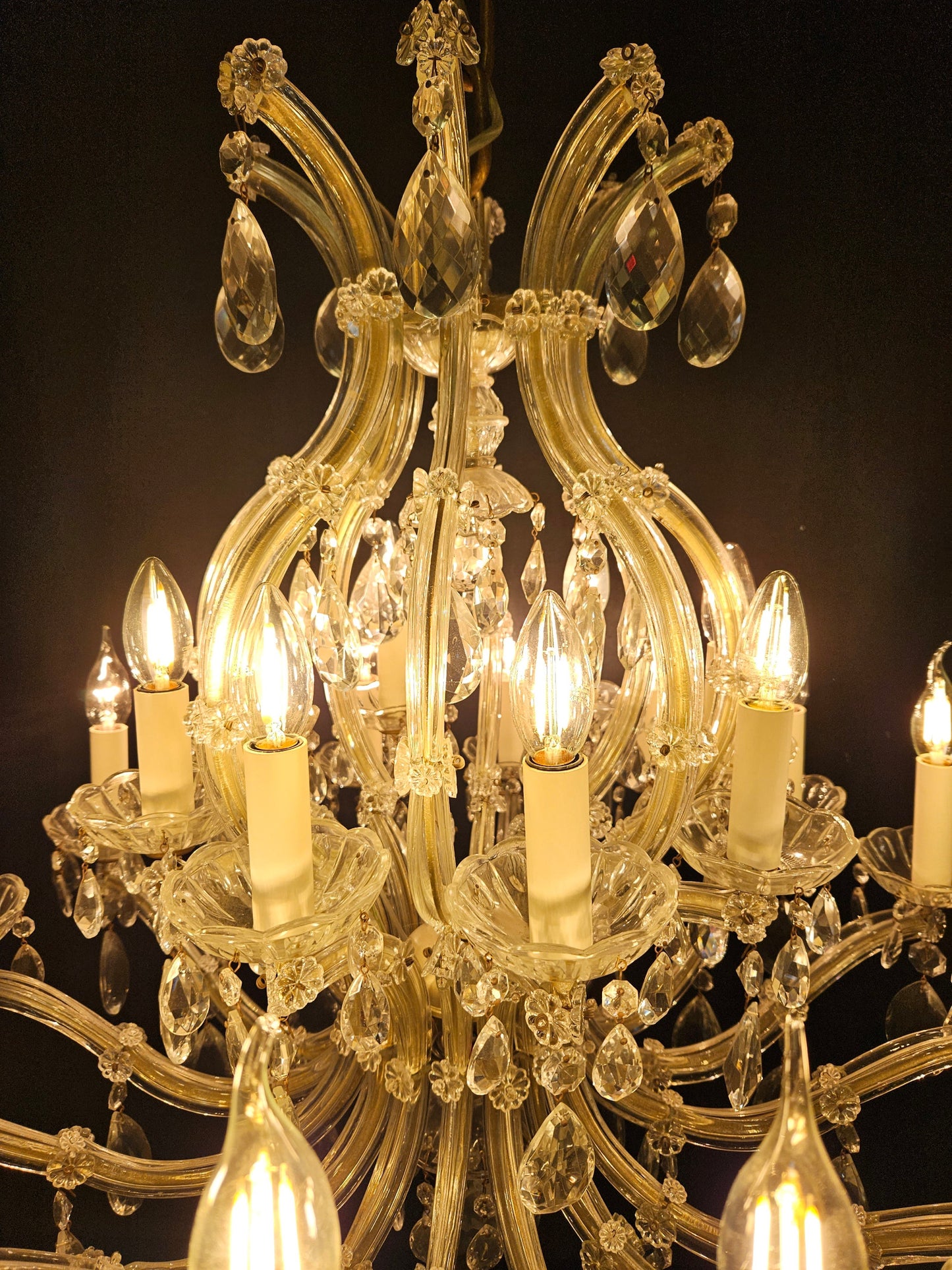 view of top half of chandelier lit up