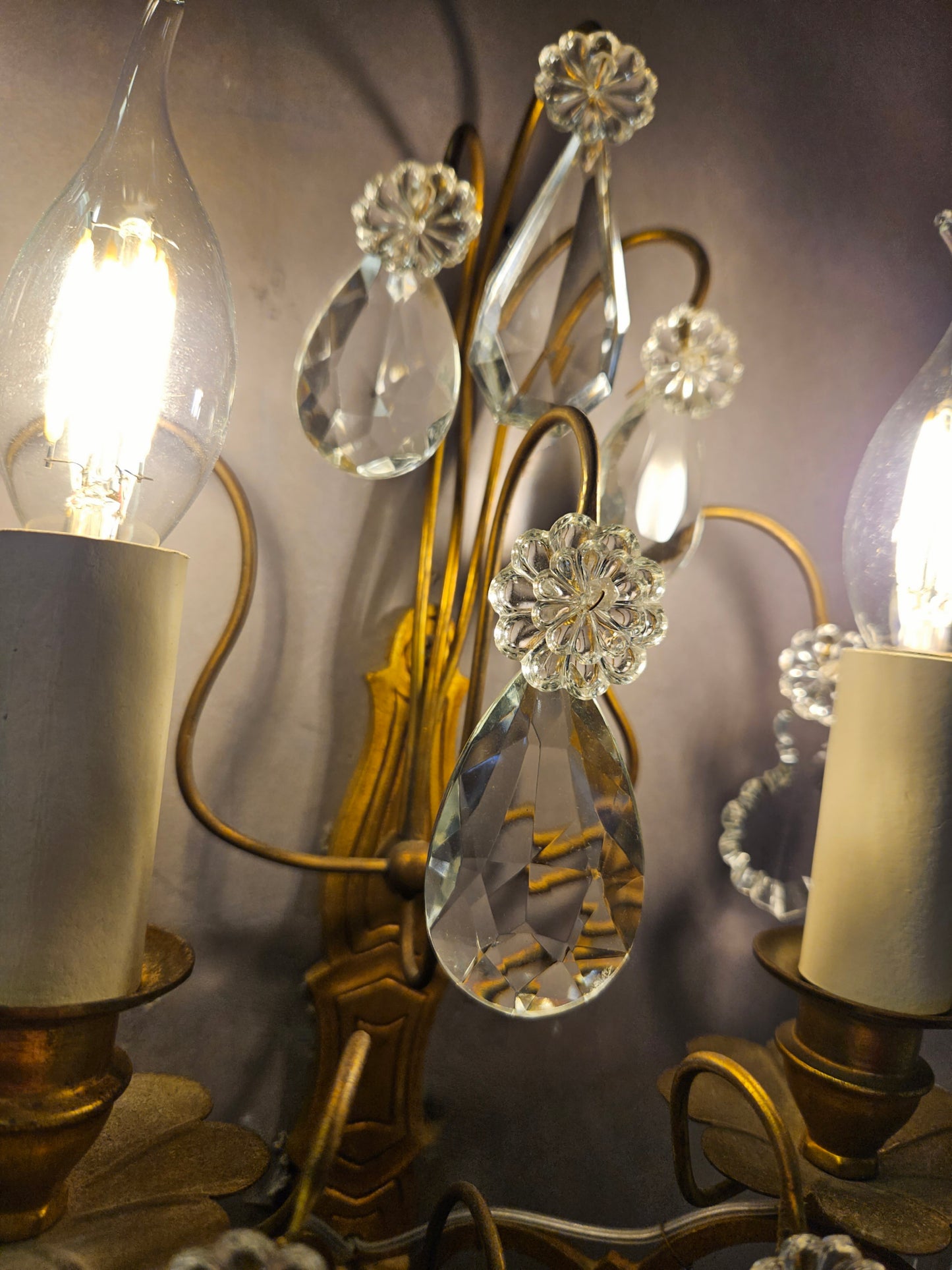 view of centre glass hanging with wall light lit