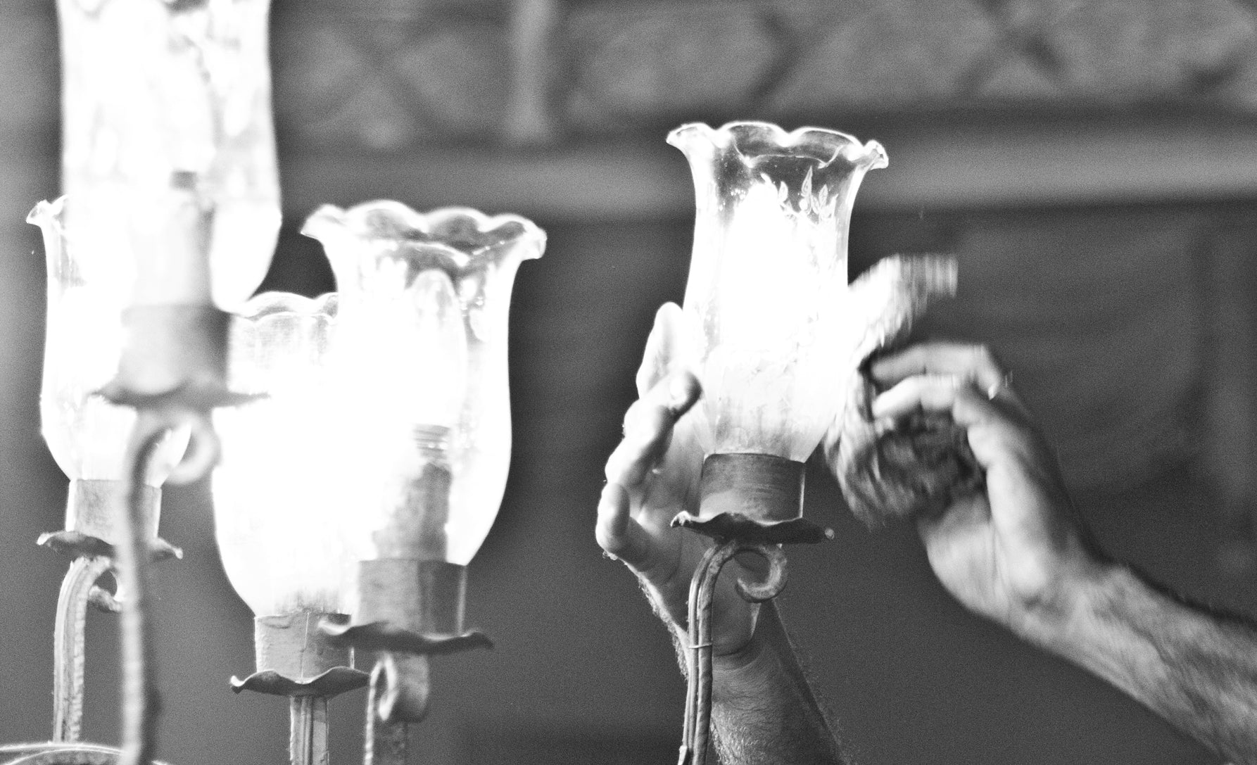 Picture showing someone cleaning a chandelier