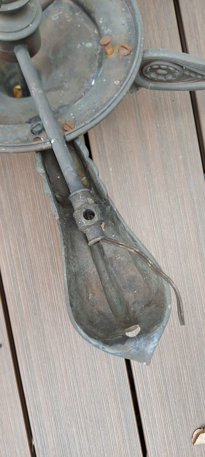 Close-up of an antique gasolier arm showing the existing fitting before modification for a colza shade.