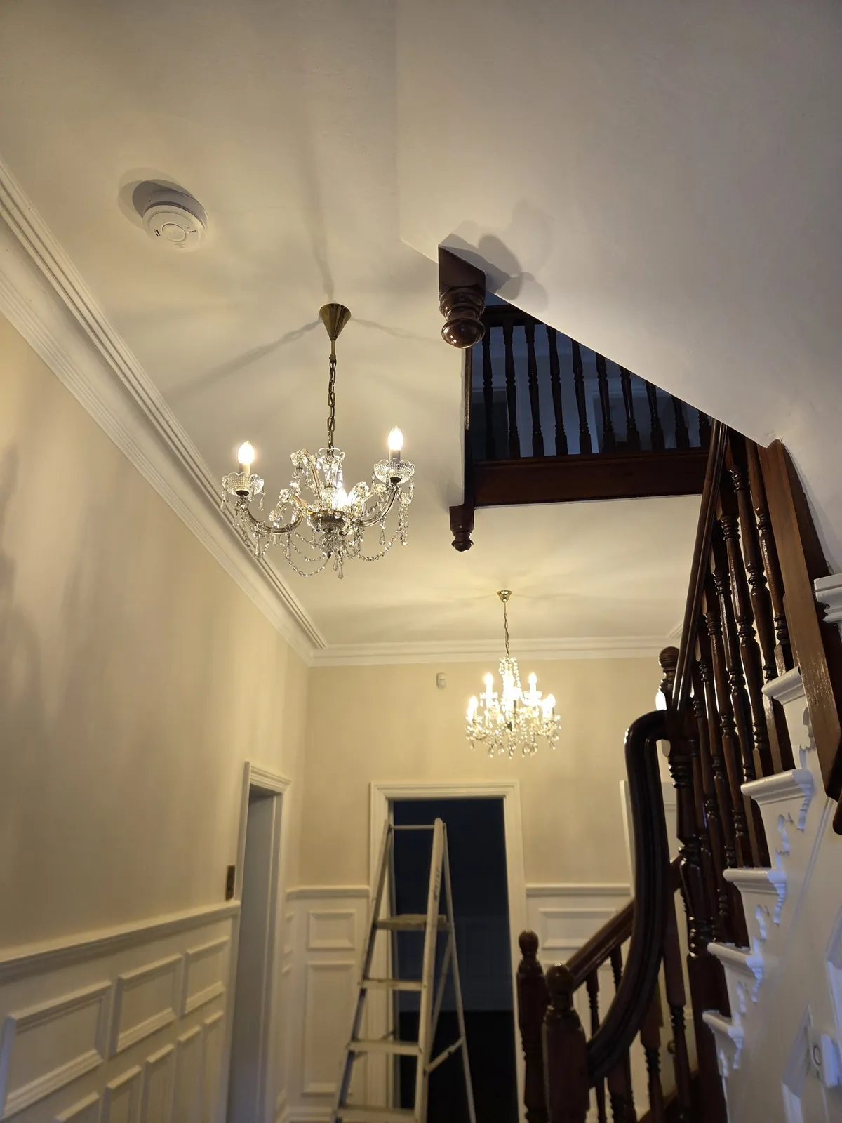 Two restored Maria Theresa crystal chandeliers rehung in the entrance hall of a private residence in Ascot.
