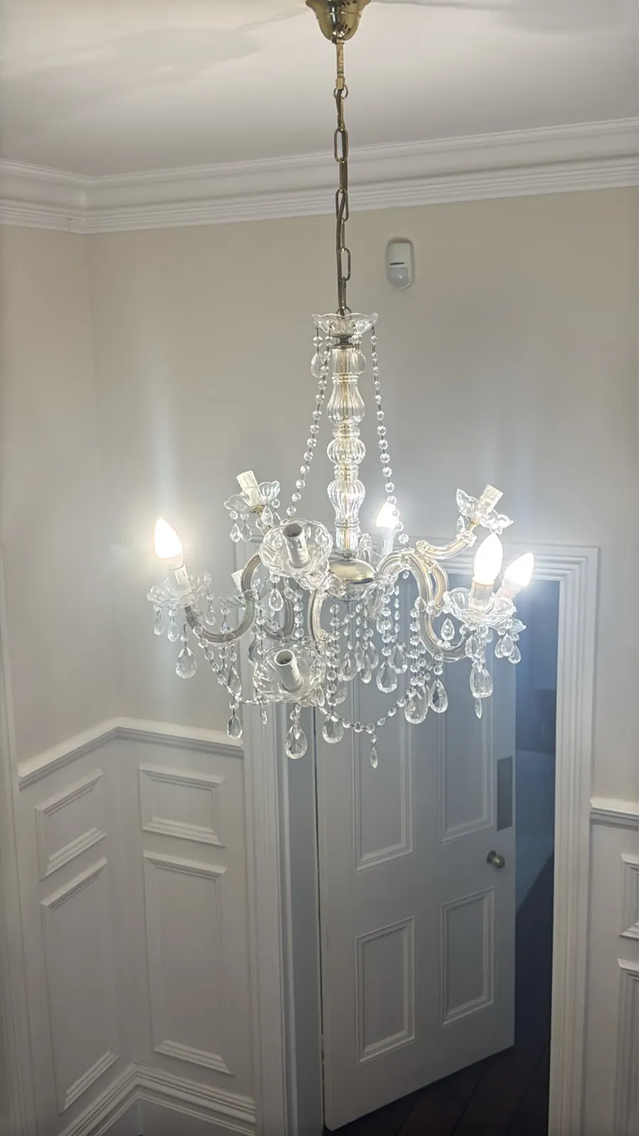 Maria Theresa crystal chandelier hanging in an Ascot residence before cleaning, repairs and re-electrification.