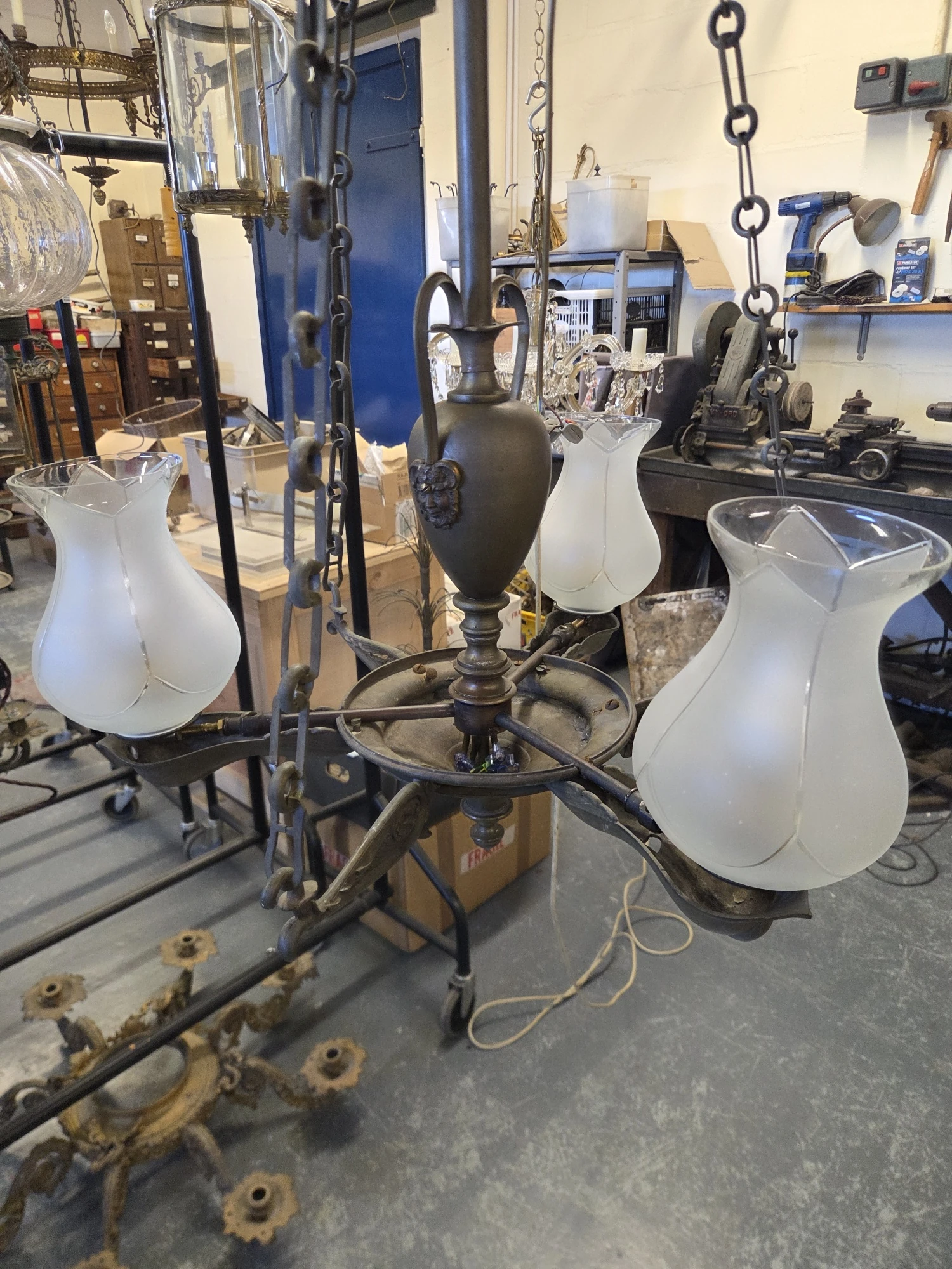 Restored antique gasolier with three colza glass shades fitted to its modified arms.