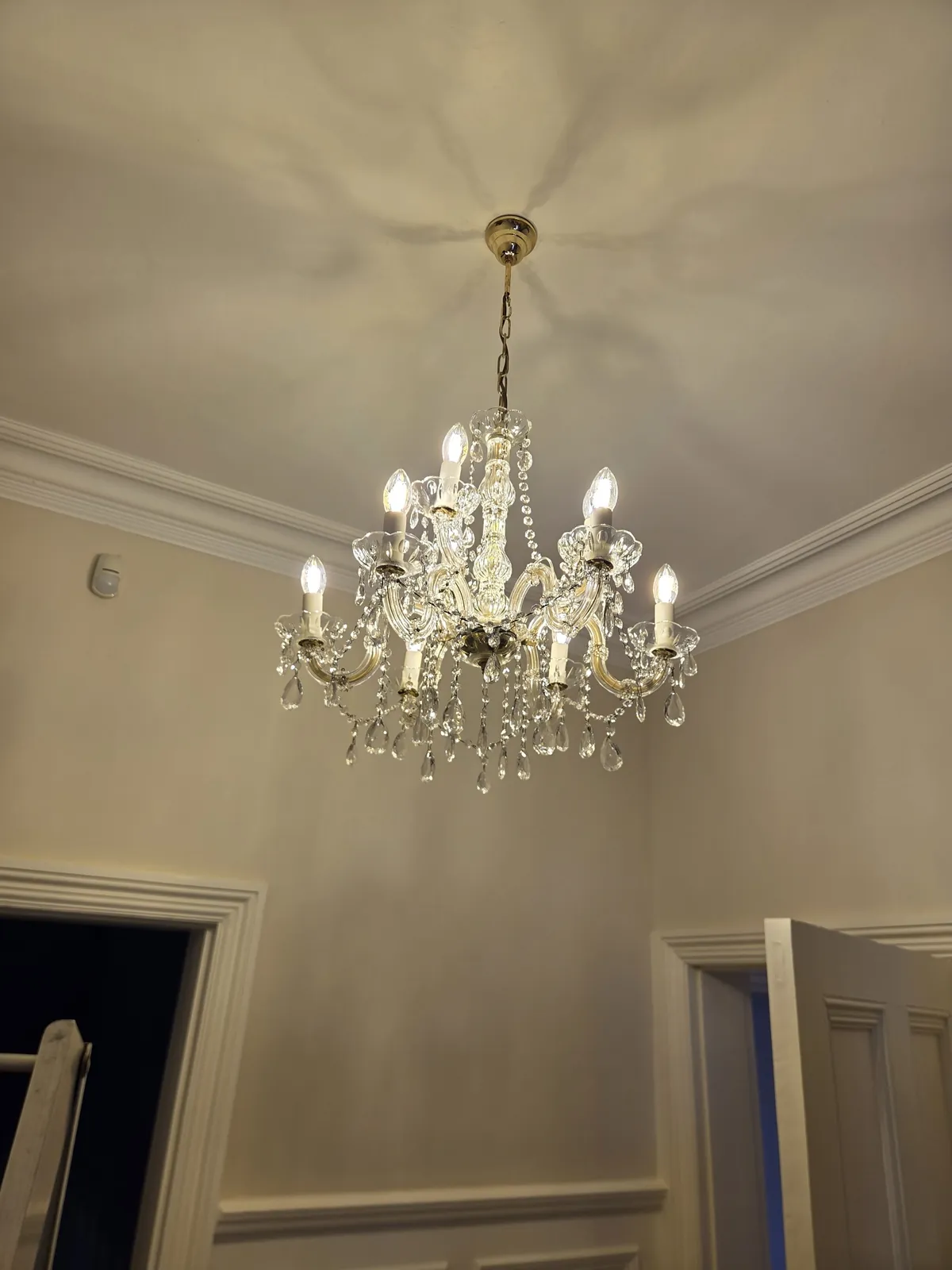 Maria Theresa crystal chandelier illuminated after workshop restoration and rewiring.