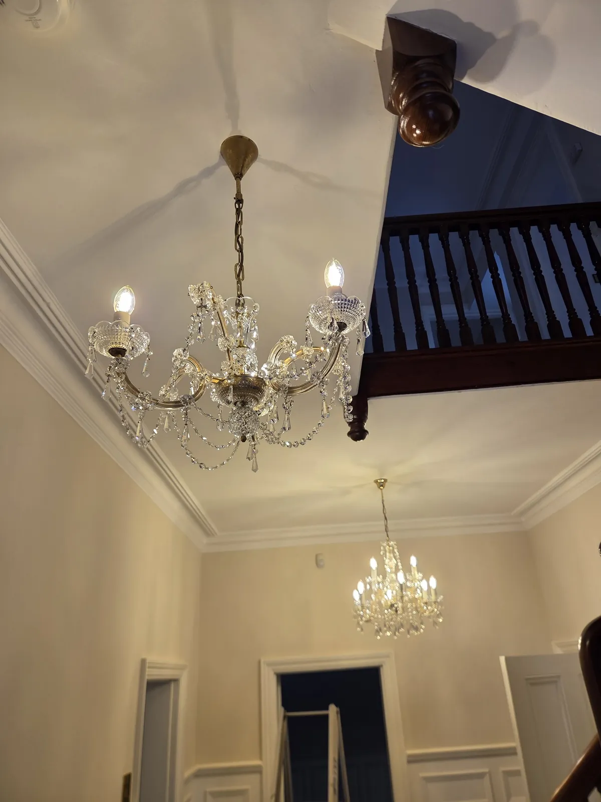 Restored Maria Theresa chandelier with glass arms and hanging crystal drops in Ascot.