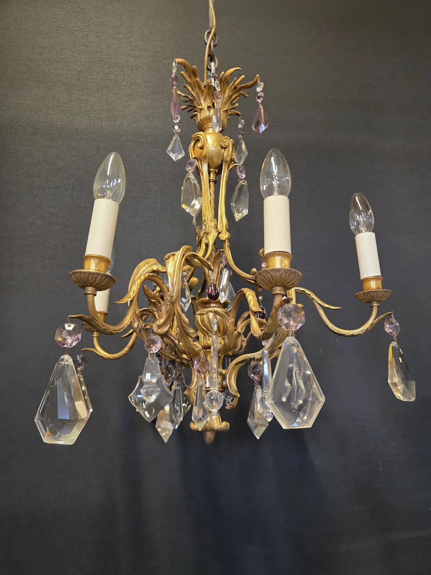 Alternative side view of the French ormolu chandelier with its six lights and clear and mauve drops