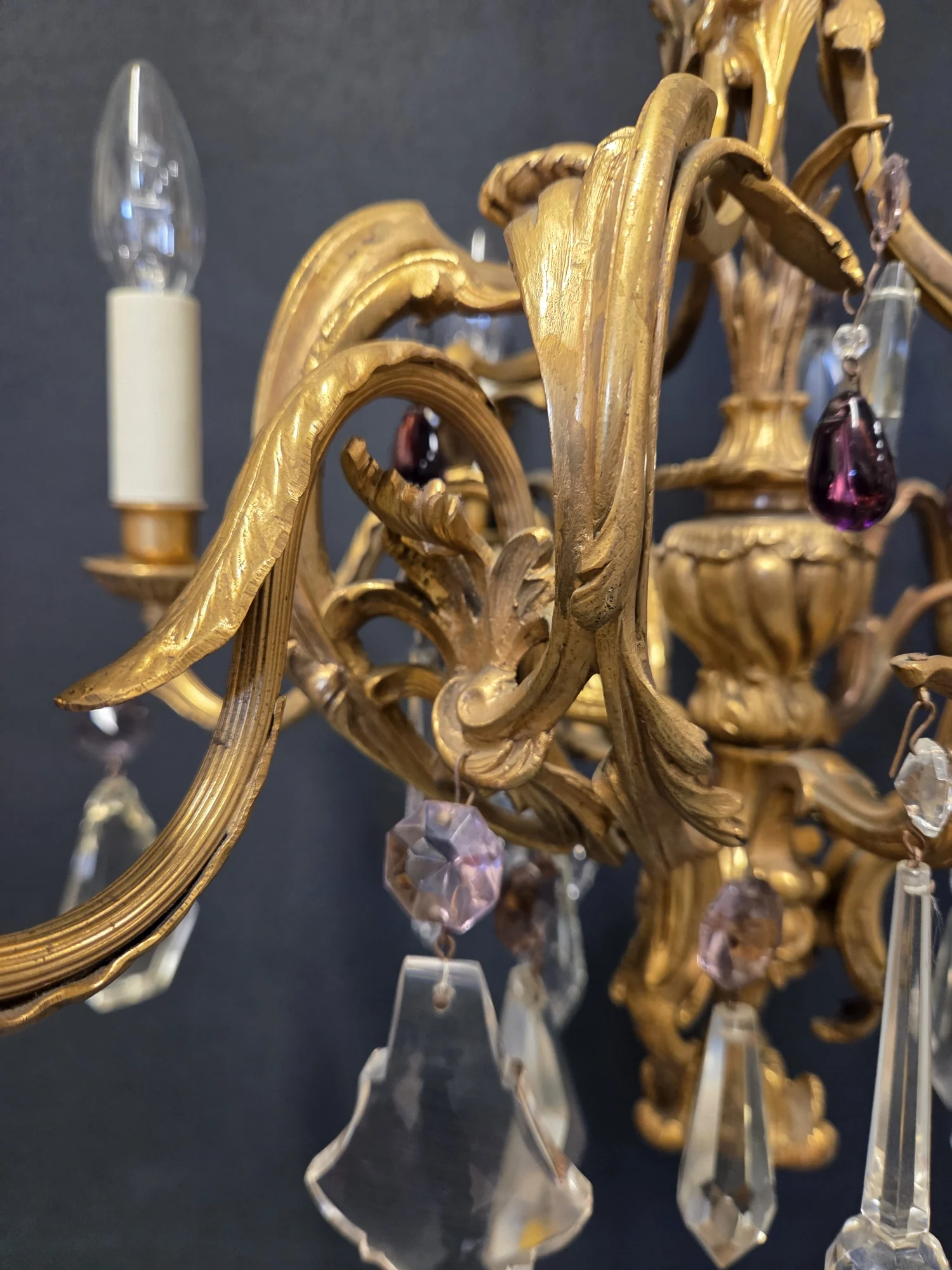 Close-up of the central ormolu urn and scrolling arms with purple and mauve glass drops