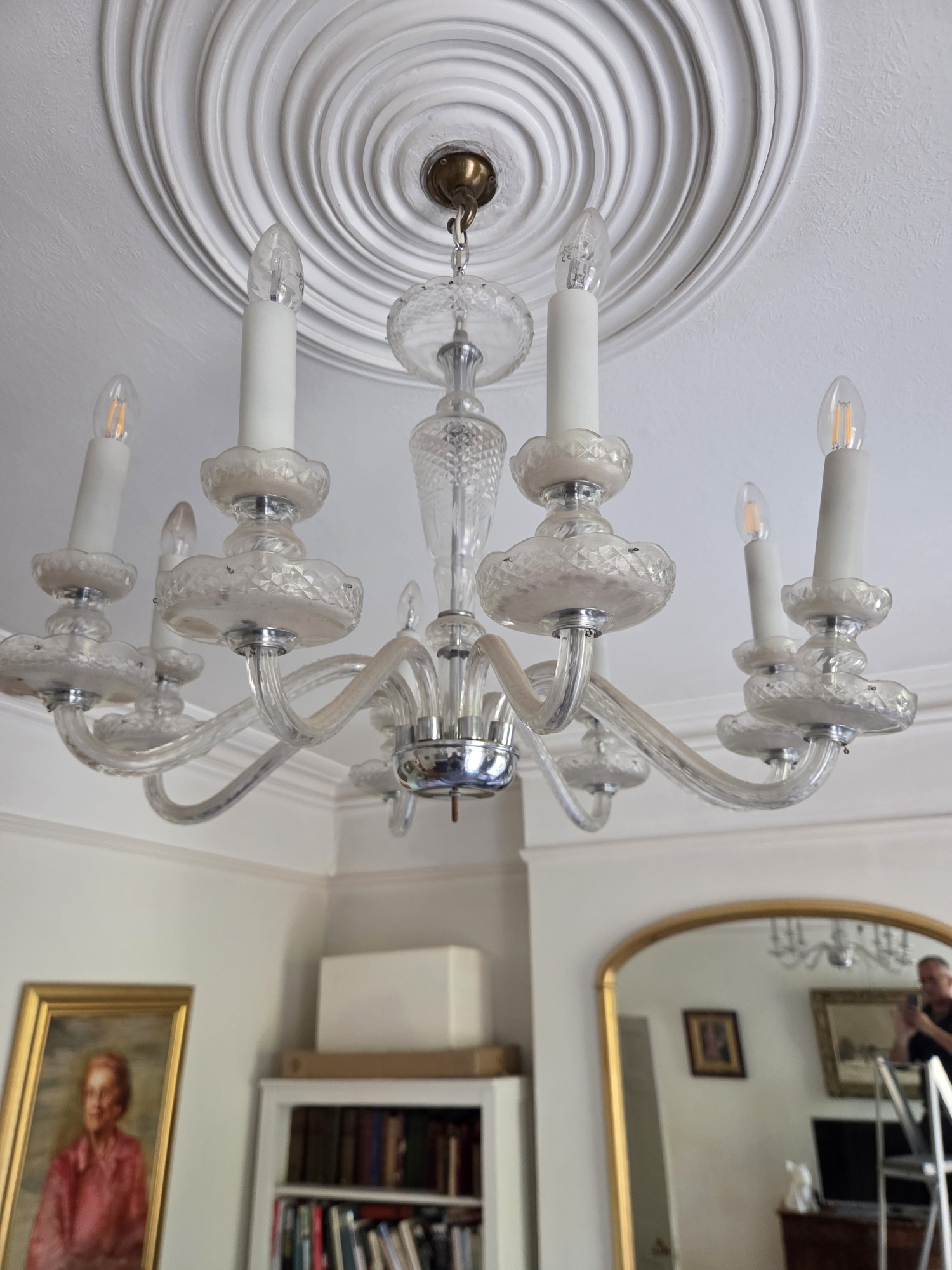 Eight-arm Czech chandelier hanging with its glass drops removed for cleaning.