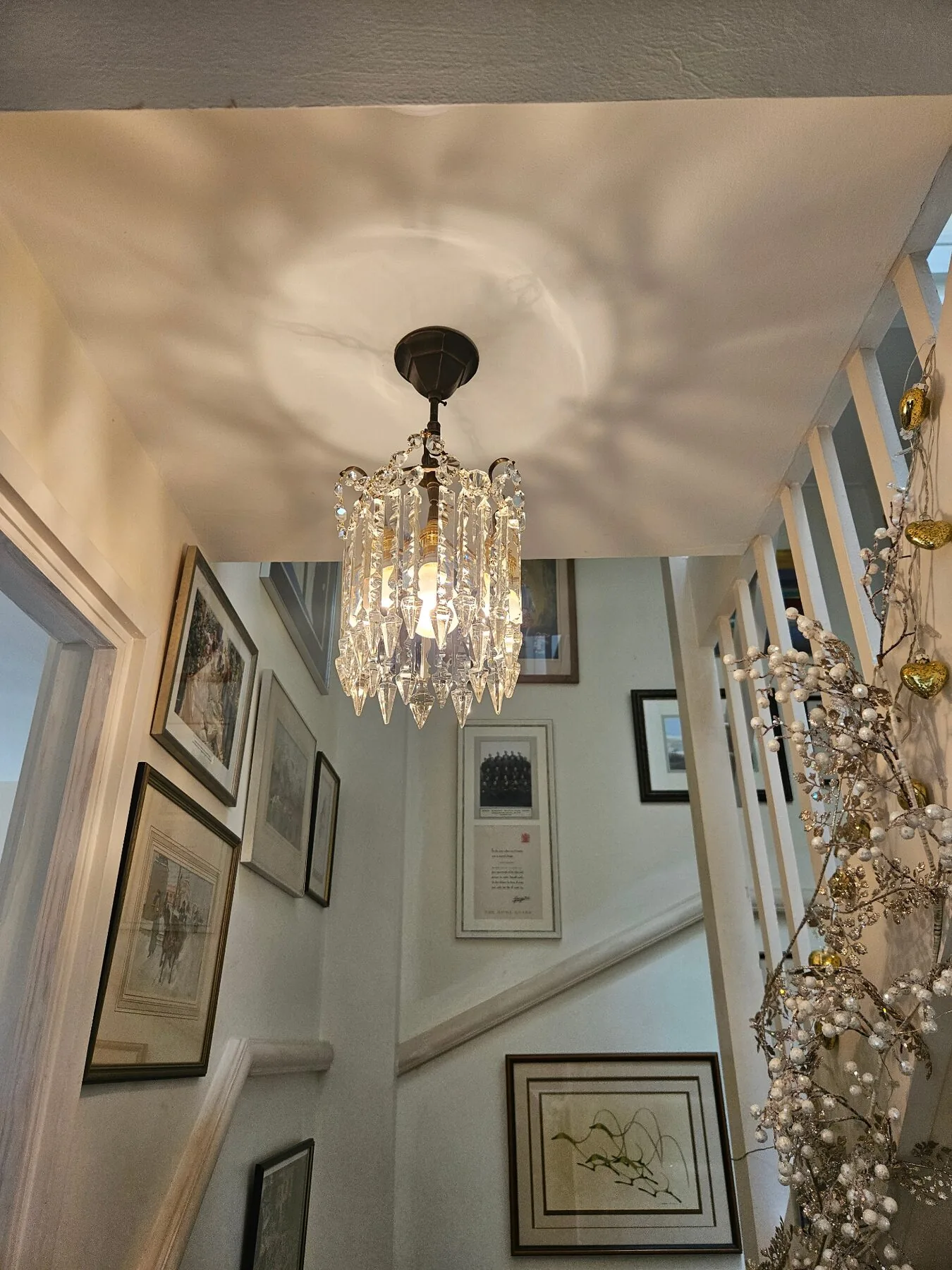 Cut Albert tiered chandelier hanging above a staircase in the new property