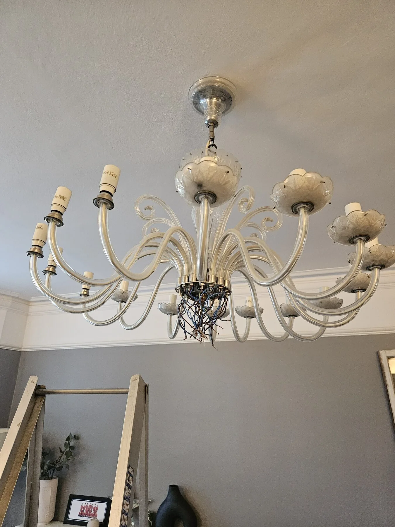 Full arm span of the antique chandelier photographed before careful takedown