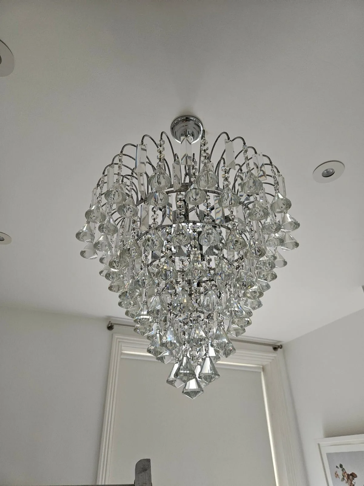 Pair of contemporary Strass crystal chandeliers after cleaning, North London