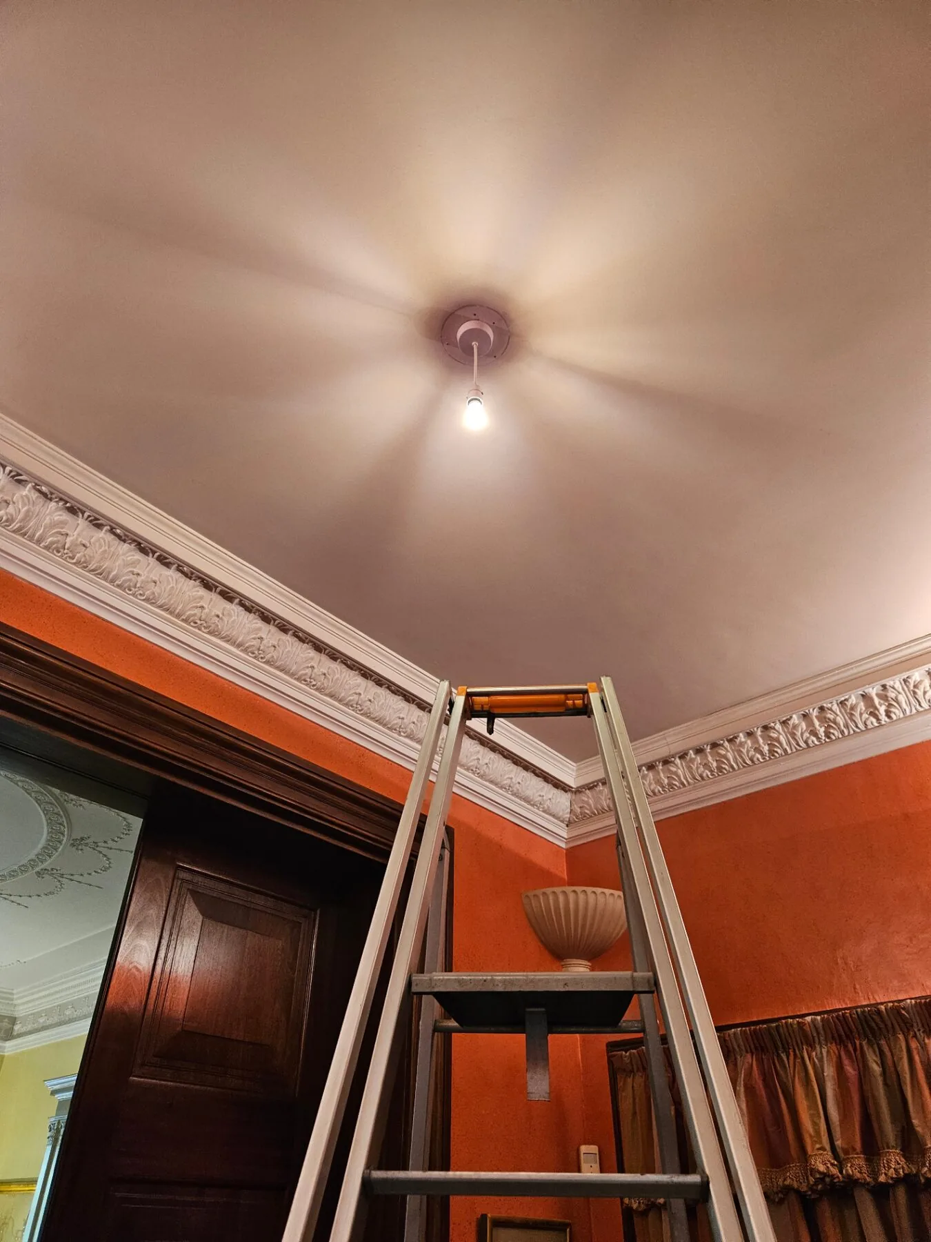Temporary pendant fitting installed at the ceiling point after removal