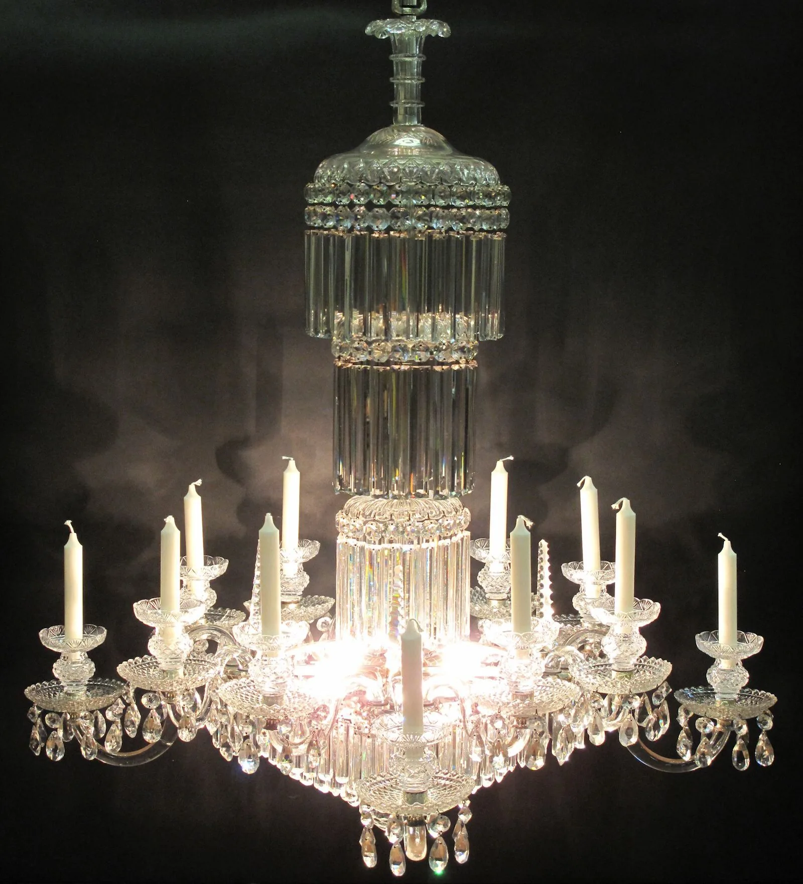 Antique cut-glass chandelier illuminated by candles