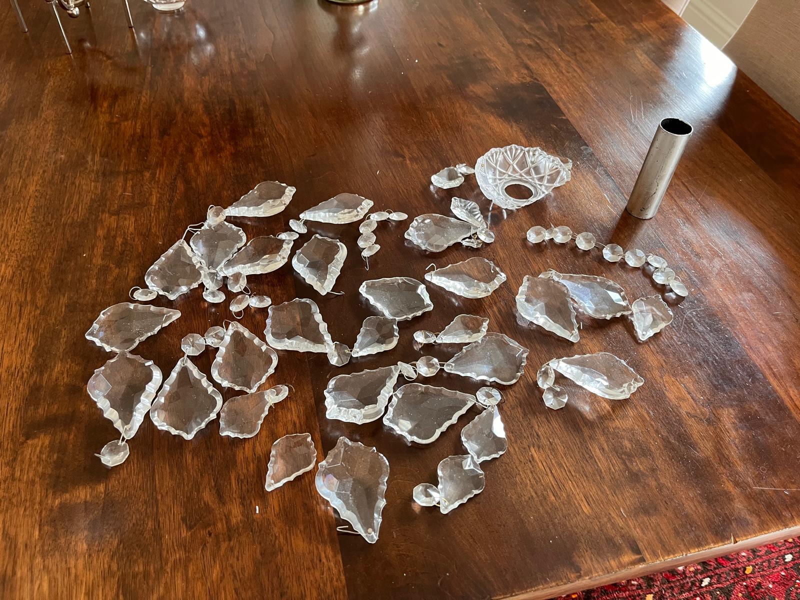 Broken pieces of hanging glass laid out on the dining table after the fall.