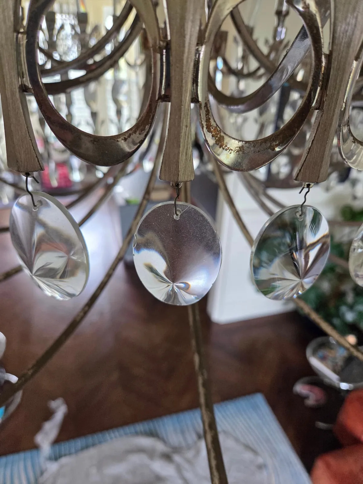 Close view of oval glass drops on a contemporary chandelier in Hampstead, London, two uncleaned and one cleaned