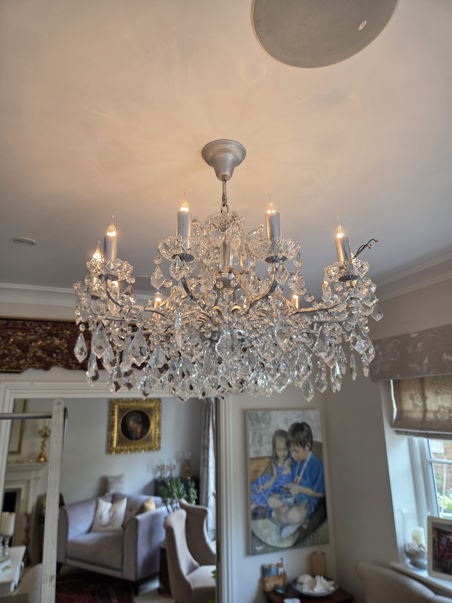 Repaired chandelier rehung above a dining table in Welwyn Garden City
