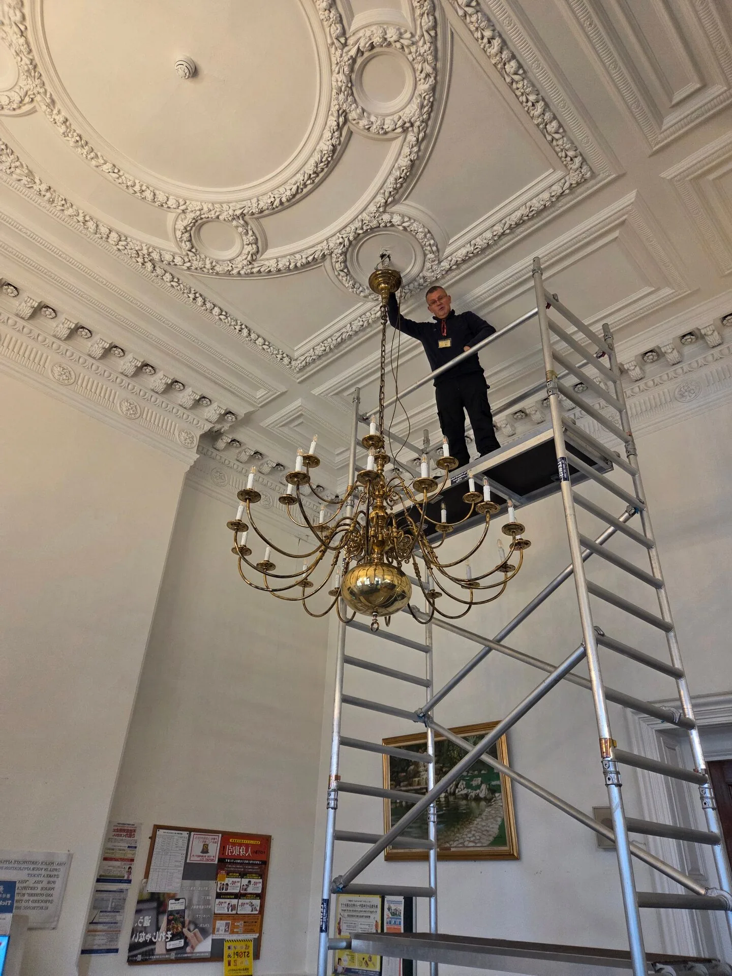 High-level chandelier cleaning using scaffolding in a period building