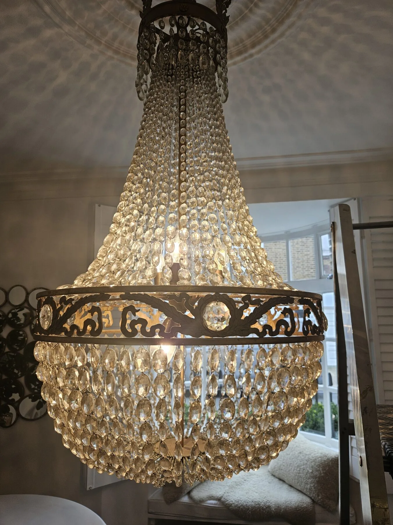 Detail of the pierced brass corona and cascading lozenge crystal drops