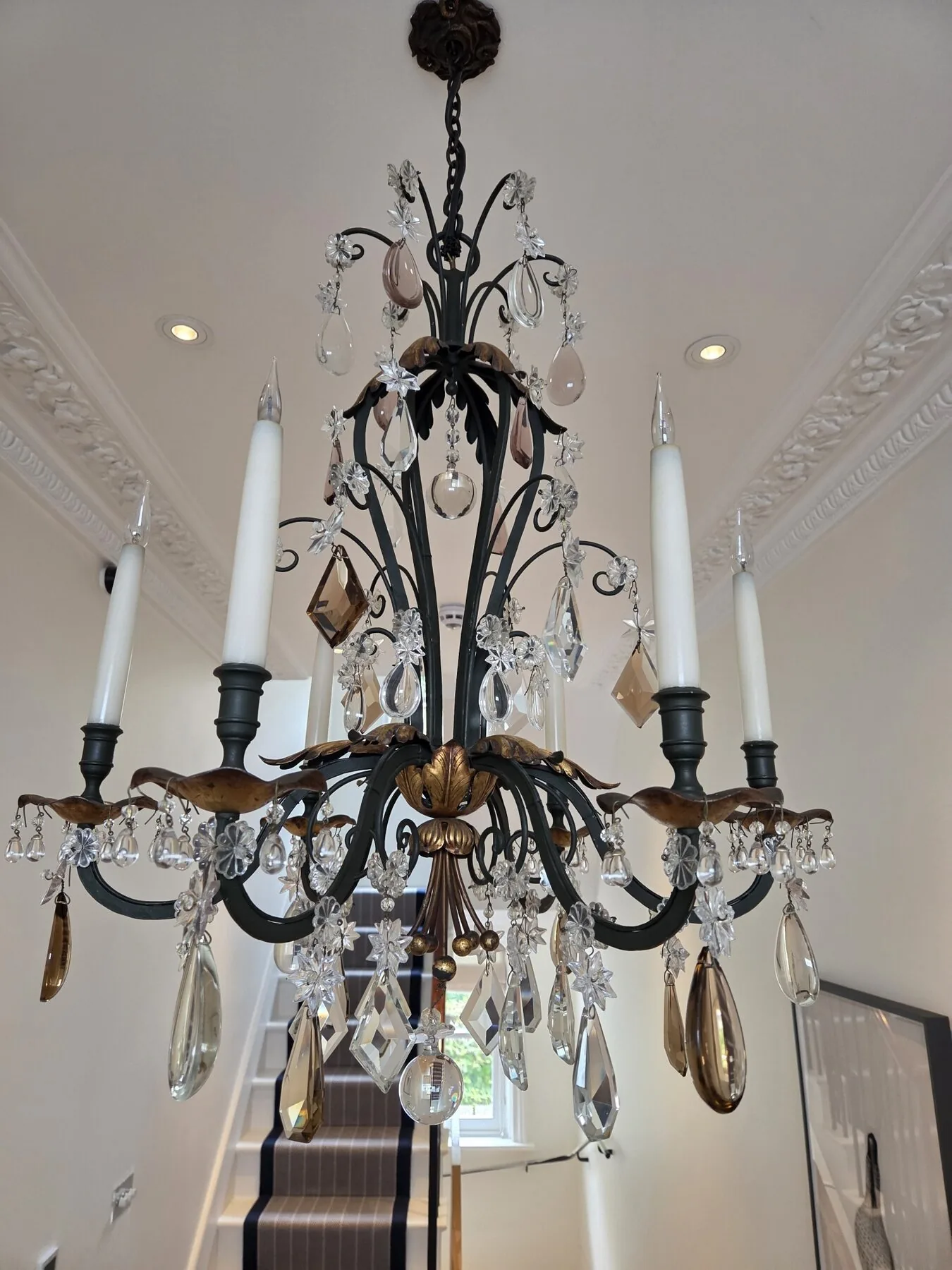 Detail of the upper corona with gilt acanthus leaves and coloured crystal pendants
