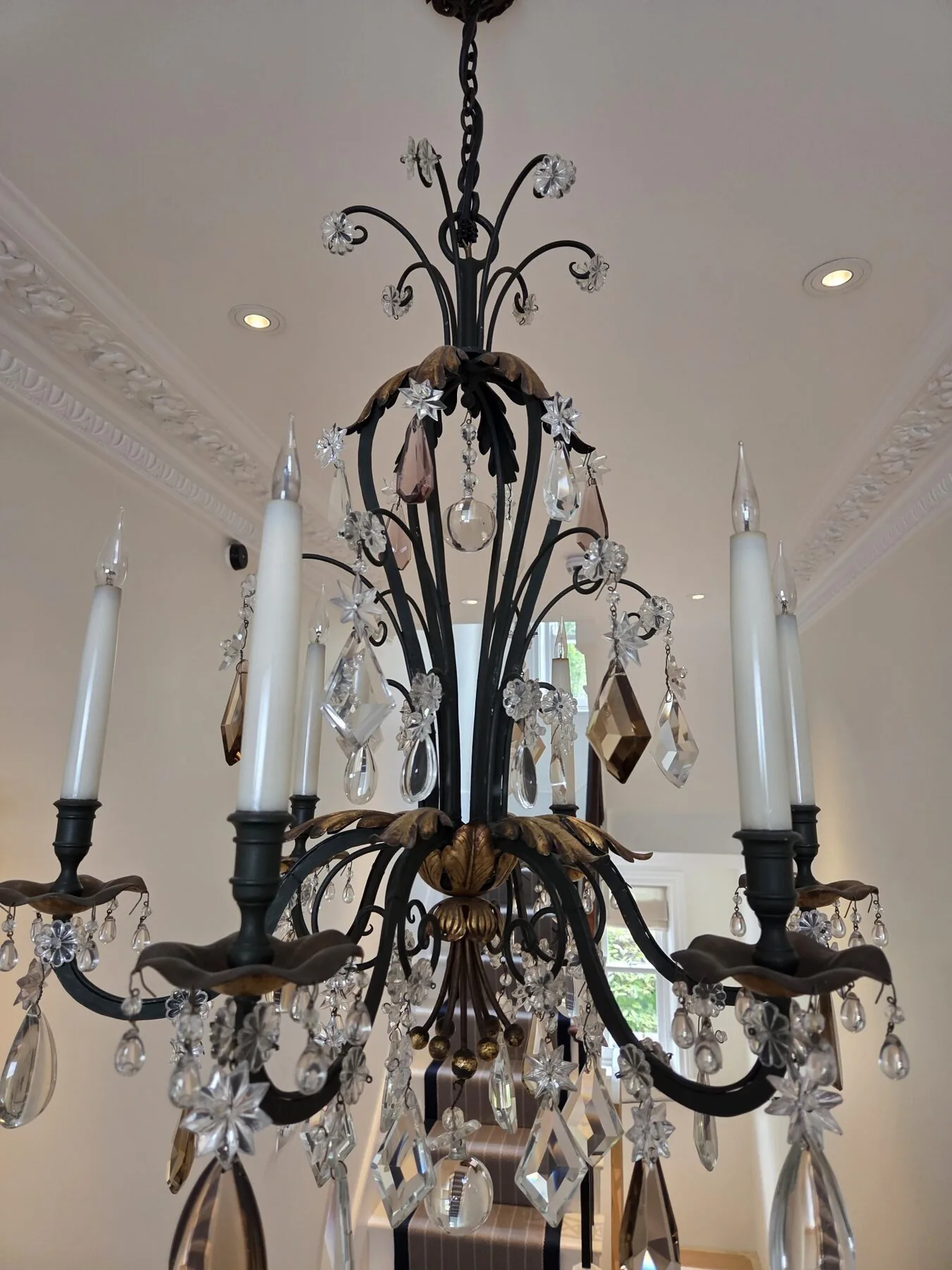 Close view of the crystal drops and gilt candle cups after hand cleaning