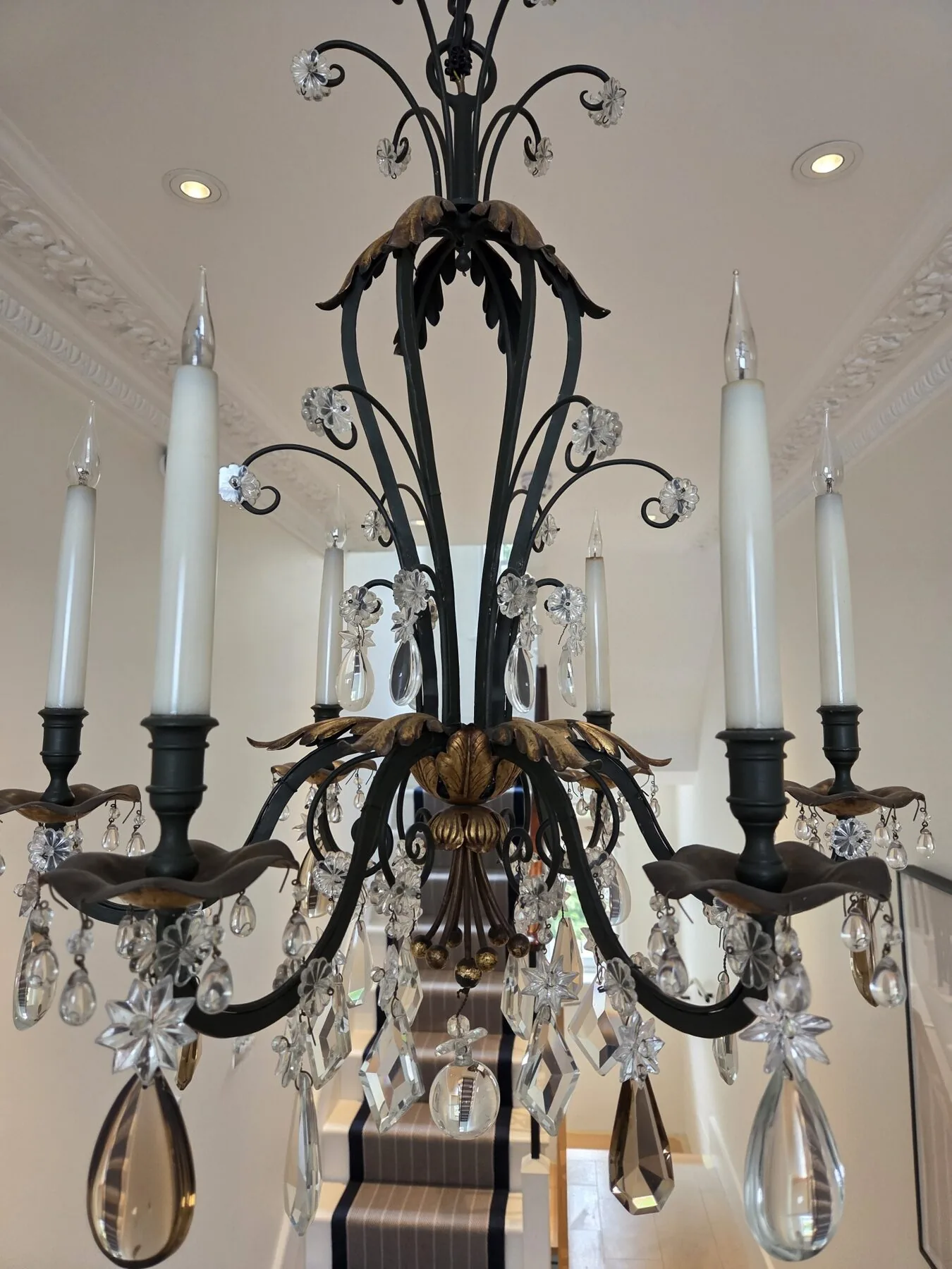 Detail of the crown with scrolling ironwork, rosettes and pear drops