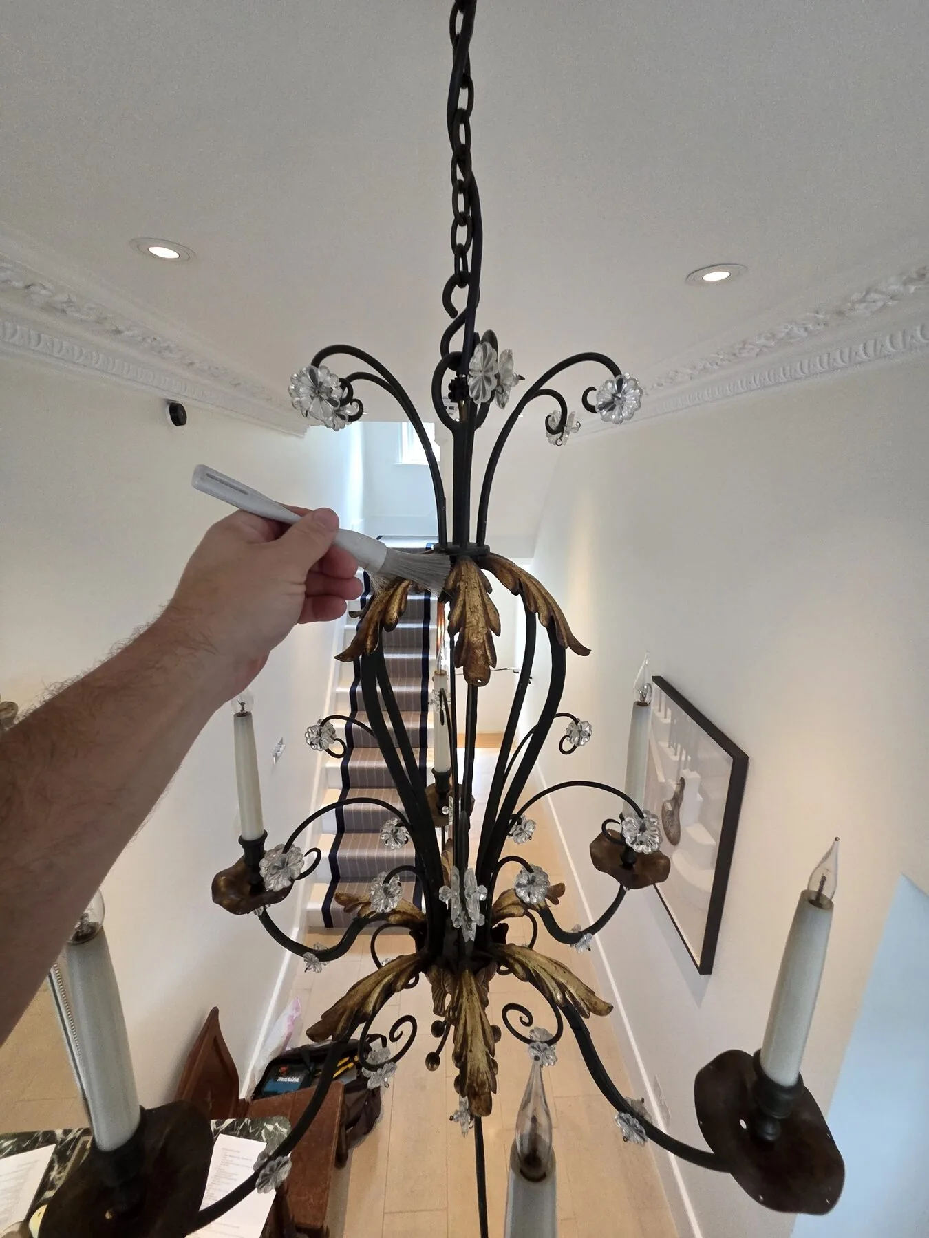 Lower corona and finial detail with gilt acanthus leaves and beaded drops
