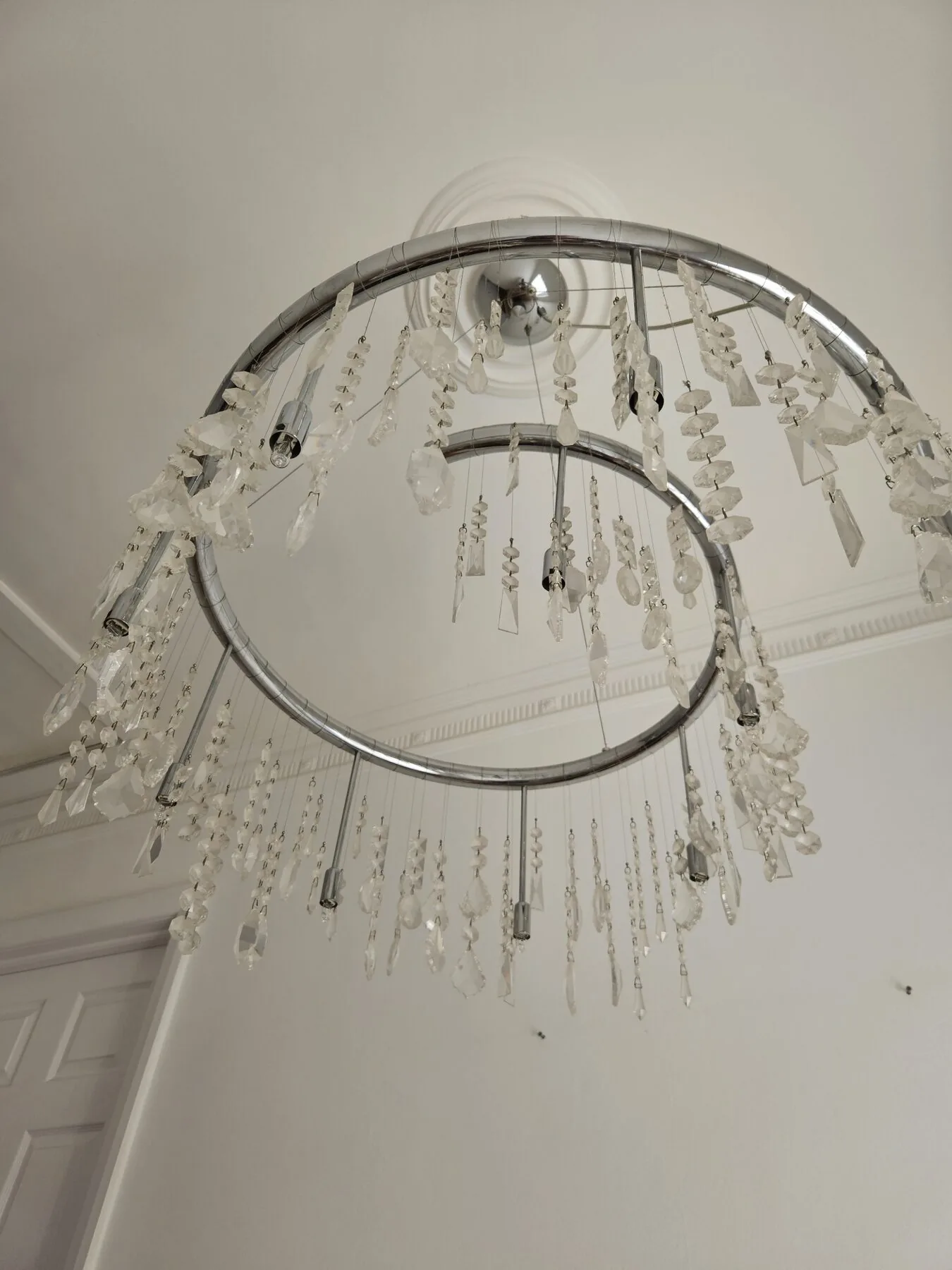 View of the chandelier from below, showing the tiered chrome rings