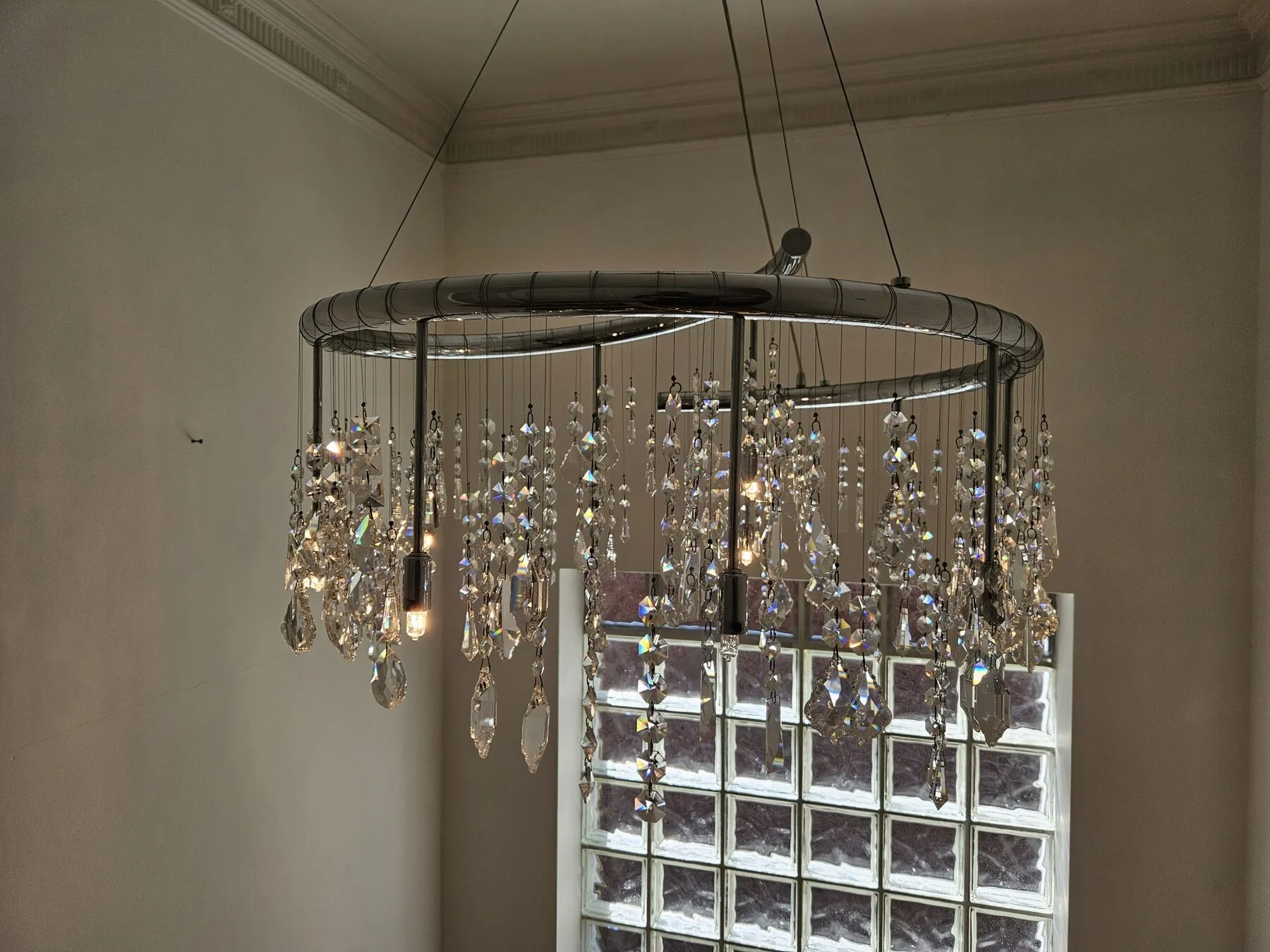 Cleaned chandelier with crystals refracting daylight