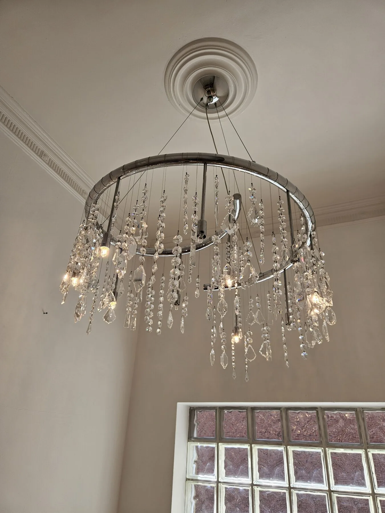 The cleaned chandelier viewed from the stairwell