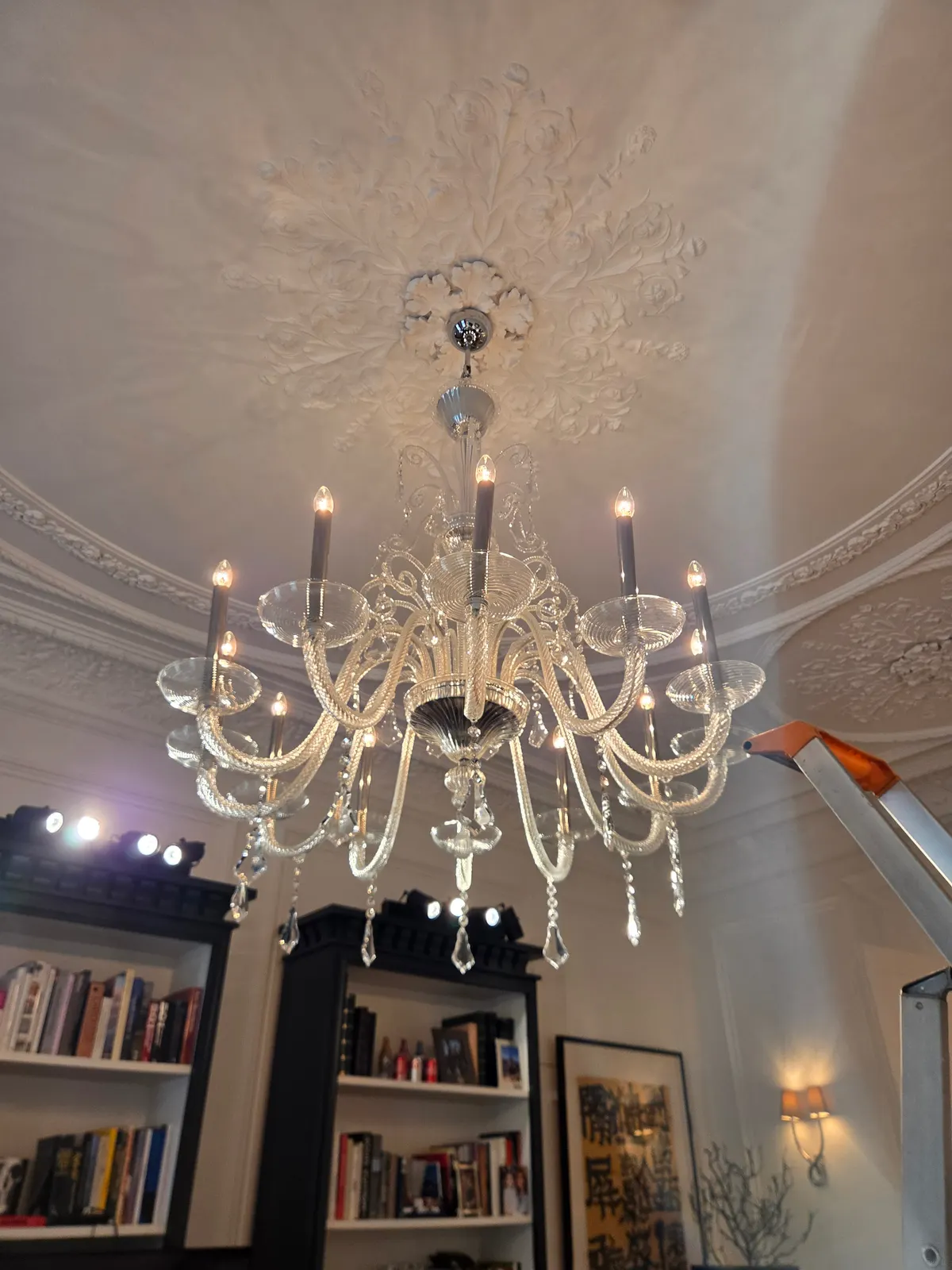 Second large Venetian chandelier cleaned in situ beneath an ornate plaster ceiling rose