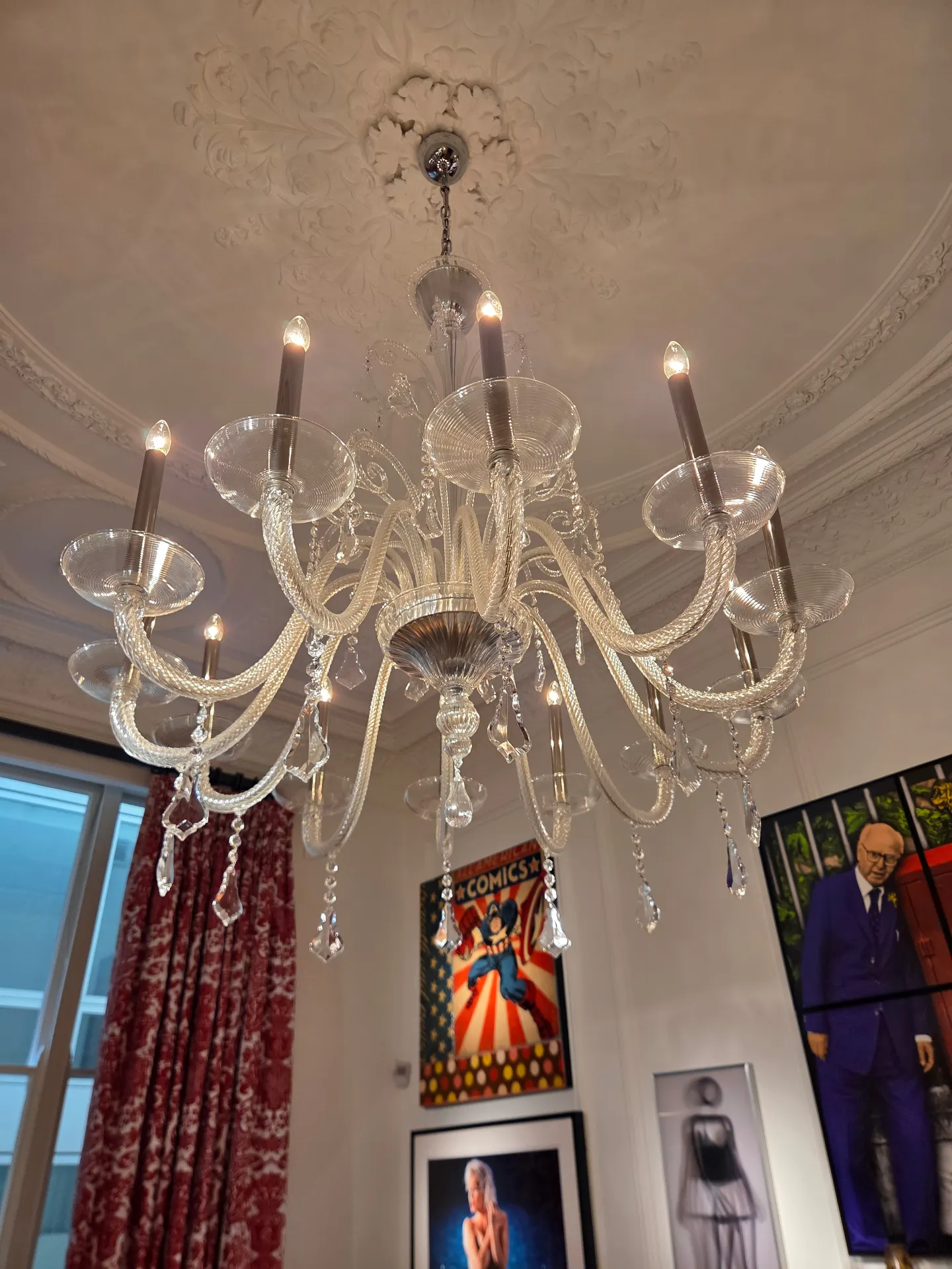 Cleaned Venetian glass chandelier lit beneath an ornate plaster ceiling rose in Lancaster Gate, London