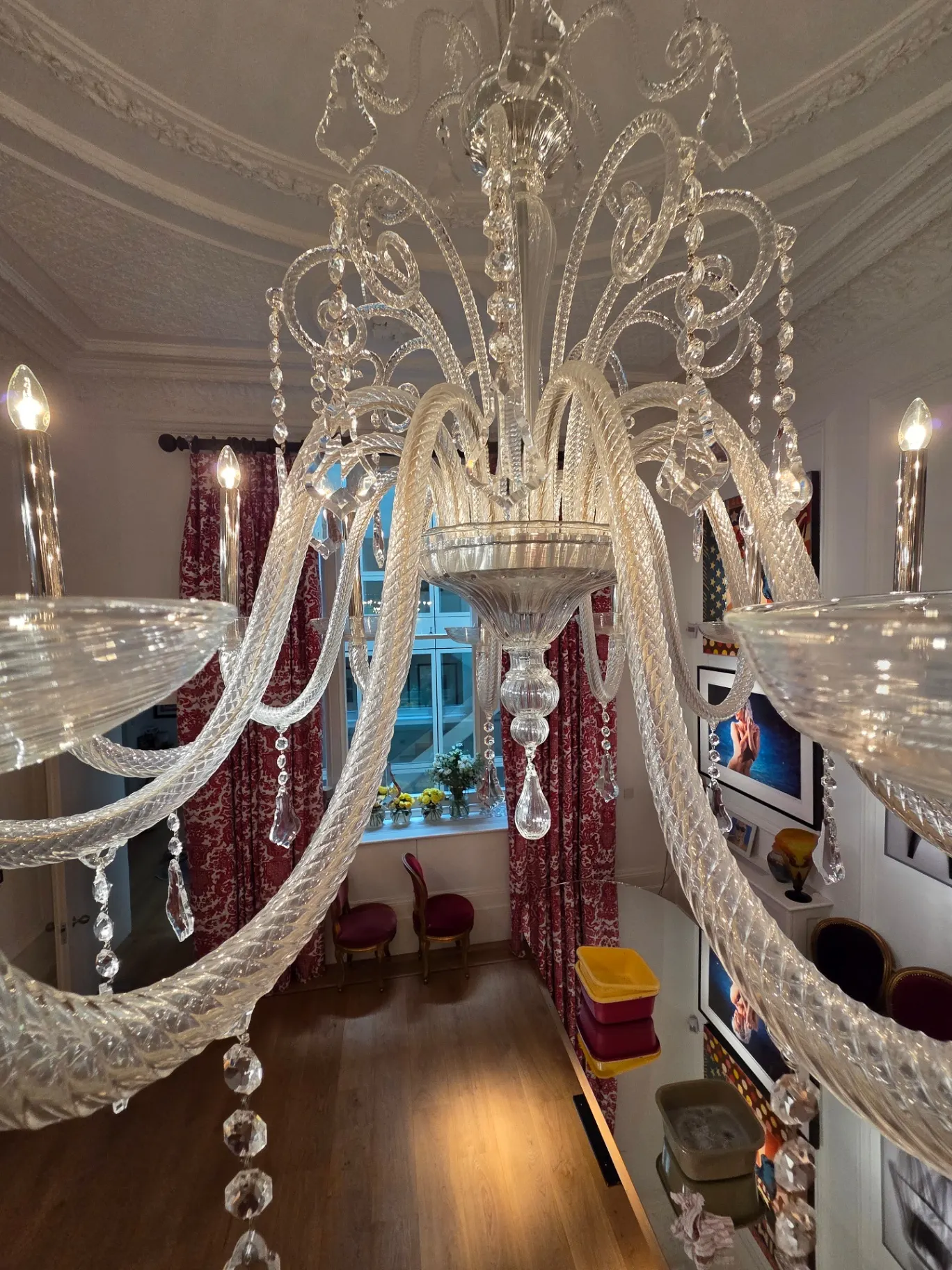 Upper glass crooks and crystal drops of a Venetian chandelier following cleaning