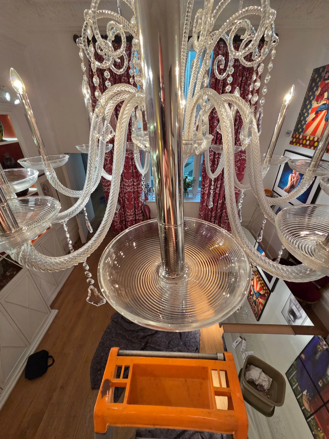 Central glass bowl and arms of a Venetian chandelier cleaned in situ from ladder height
