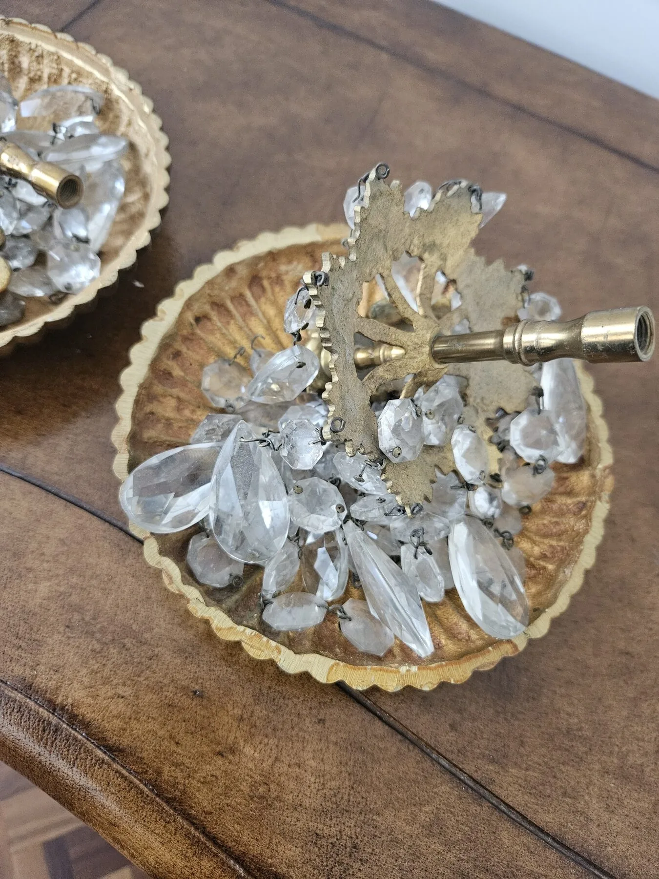 Close view of a bobèche with pear-drop crystals during workshop cleaning