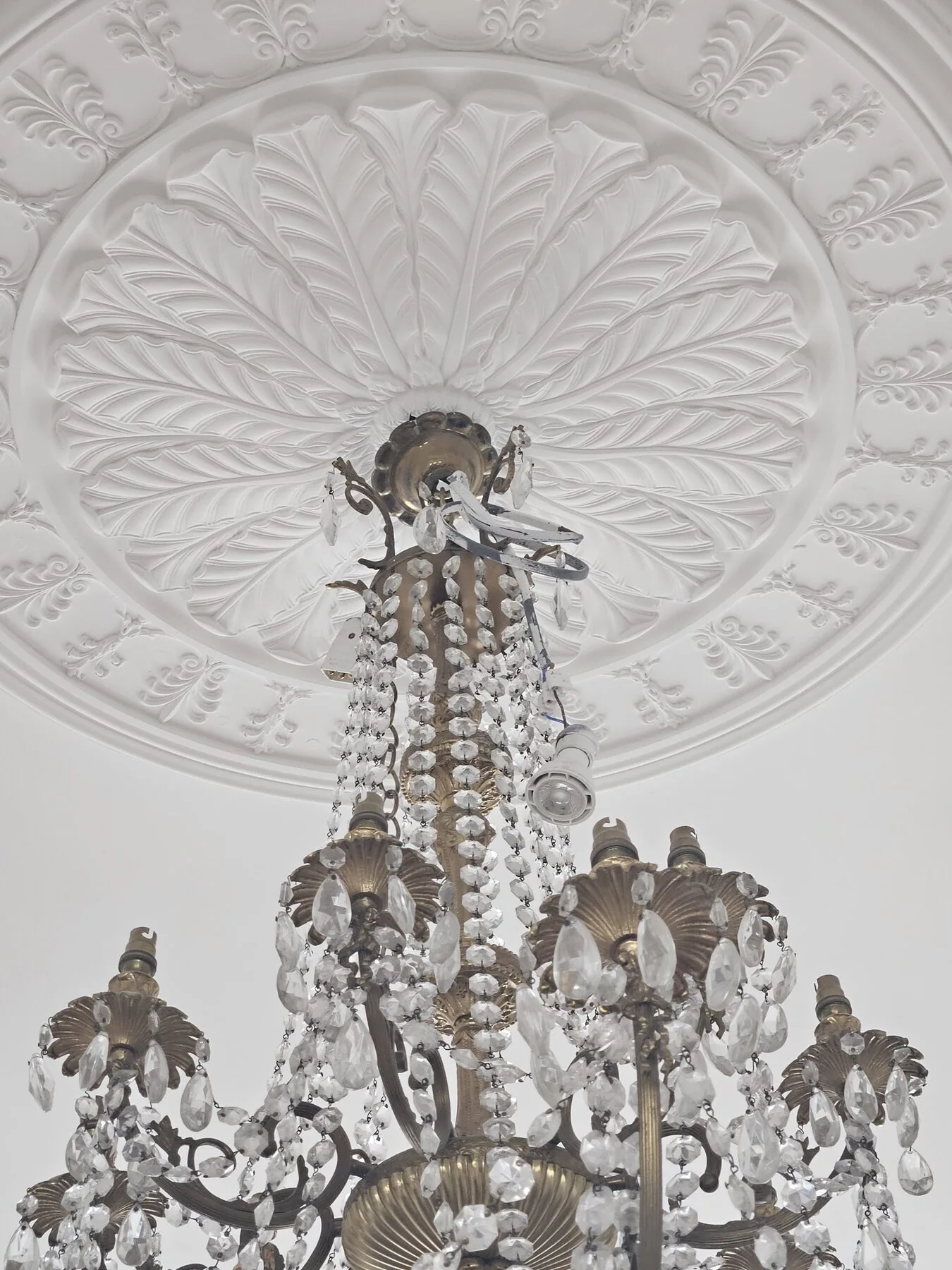 Close view of the upper corona and suspension of the Italian chandelier with wiring exposed
