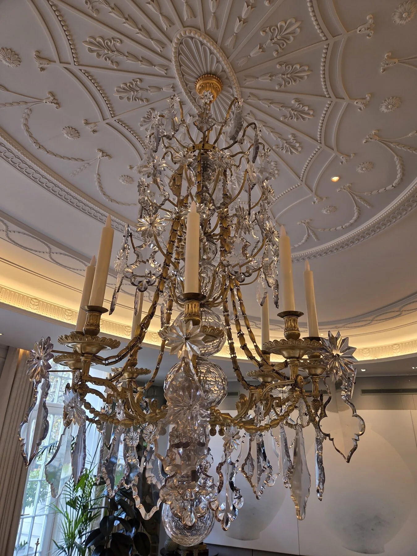 Detail of the gilded brass frame and cut crystal drops of the French chandelier