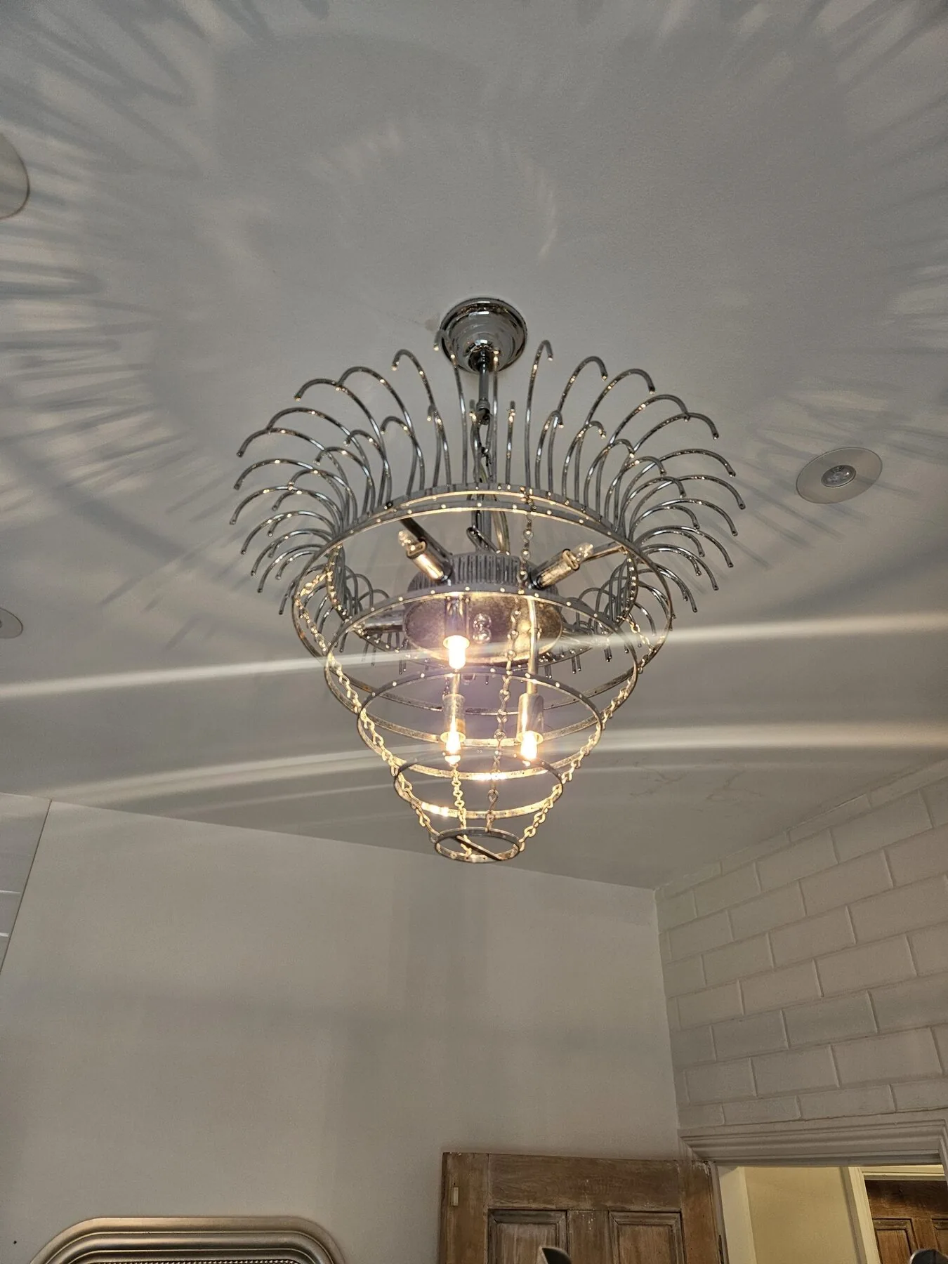 Chandelier reinstated after hand cleaning, North London