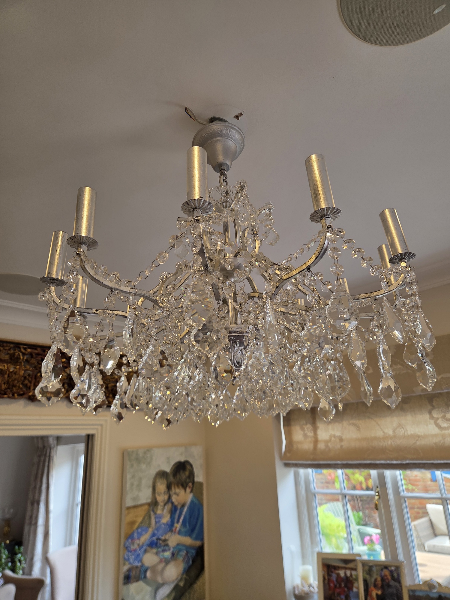 The repaired chandelier rehung above the dining table in Welwyn Garden City.