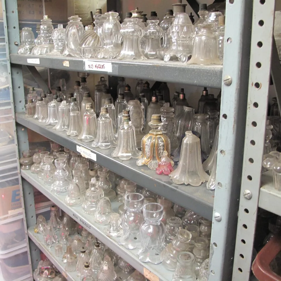 Workshop shelves with antique chandelier glass nozzles and components