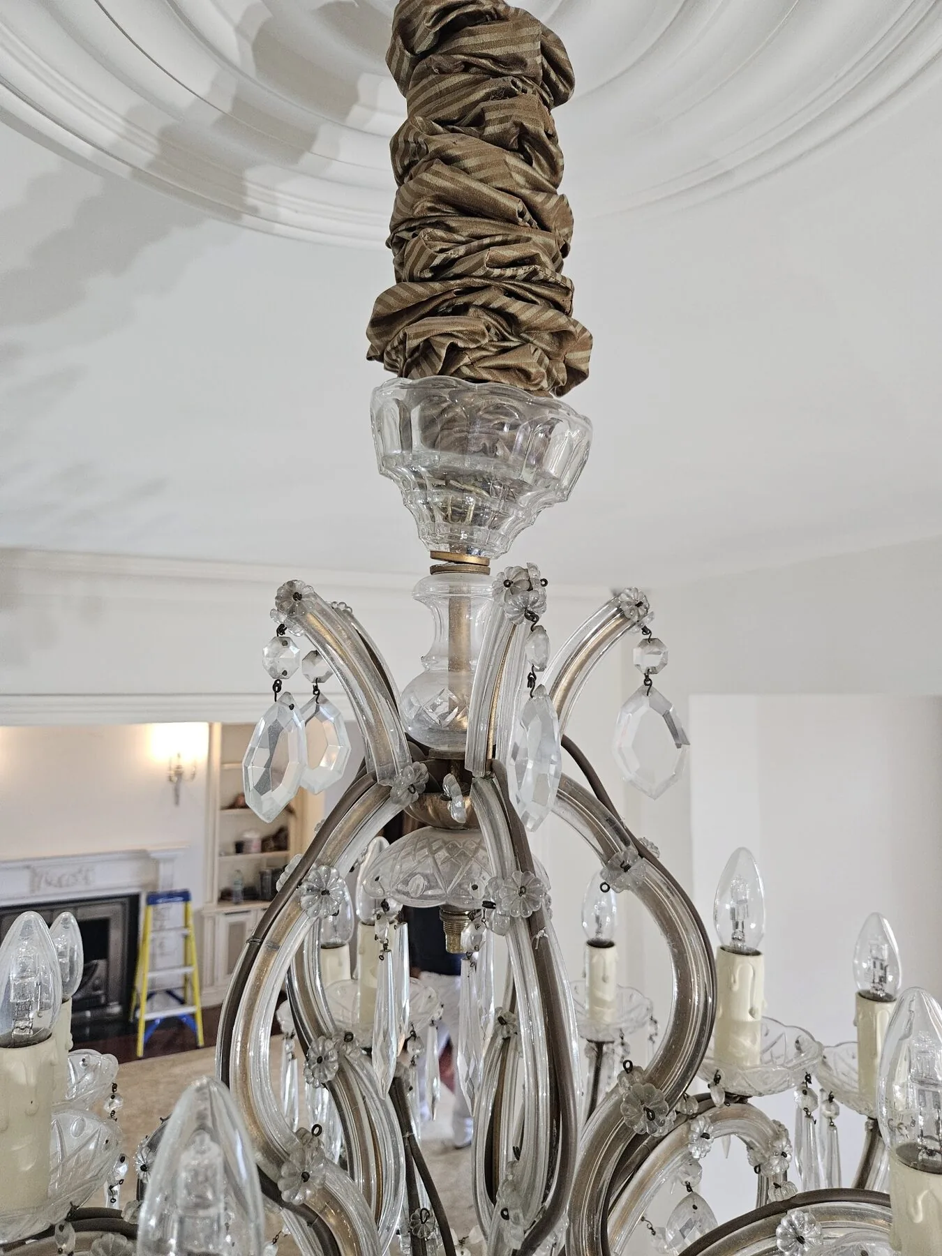 Detail of the scrolled glass arms and floral crystal rosettes