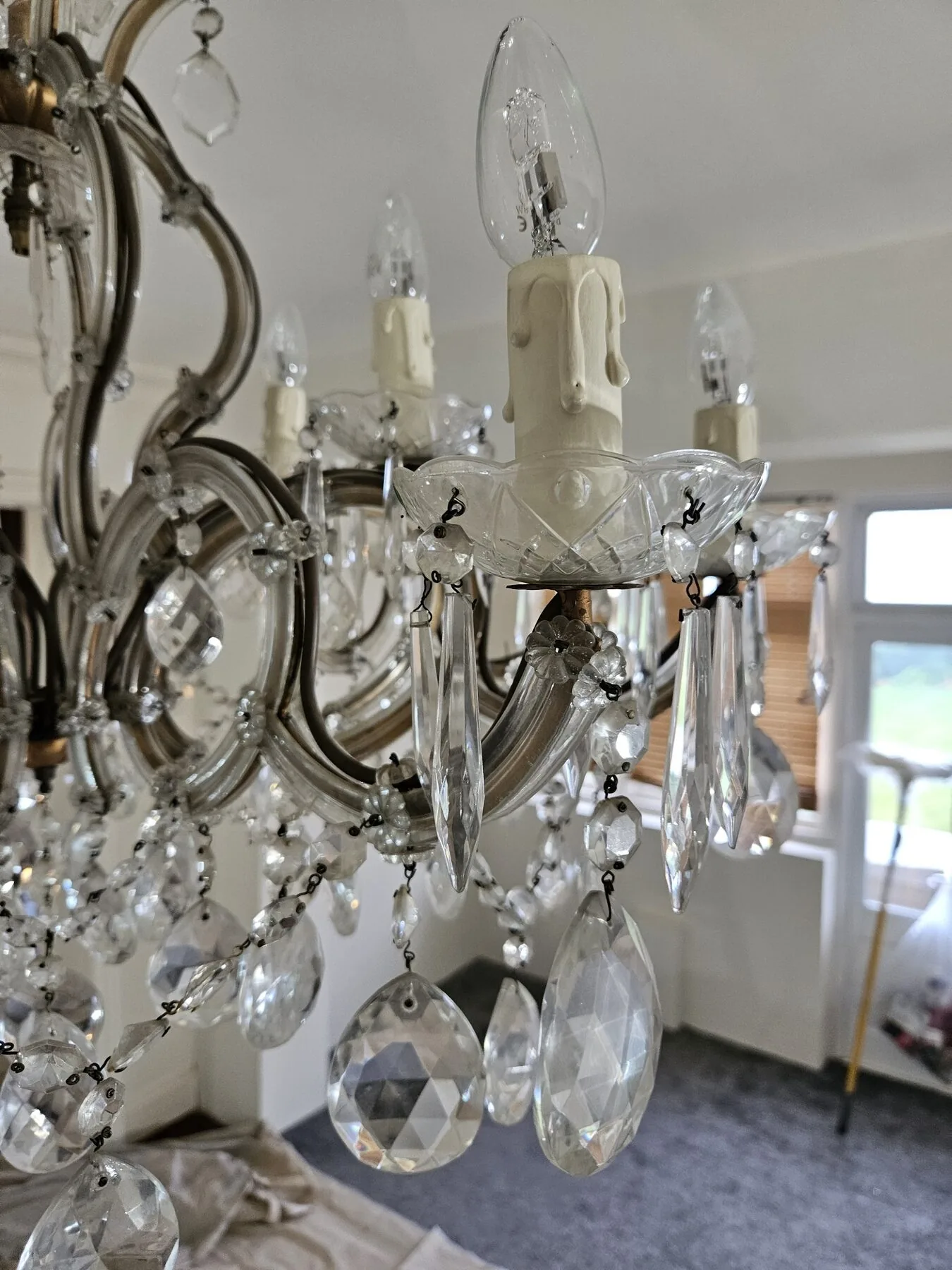 Close-up of a candle cup, drip pan and cut crystal drops