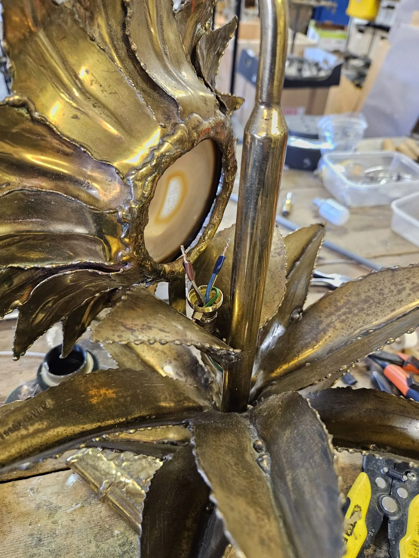 New wiring and lamp holder being fitted within the flower head of the sunflower lamp