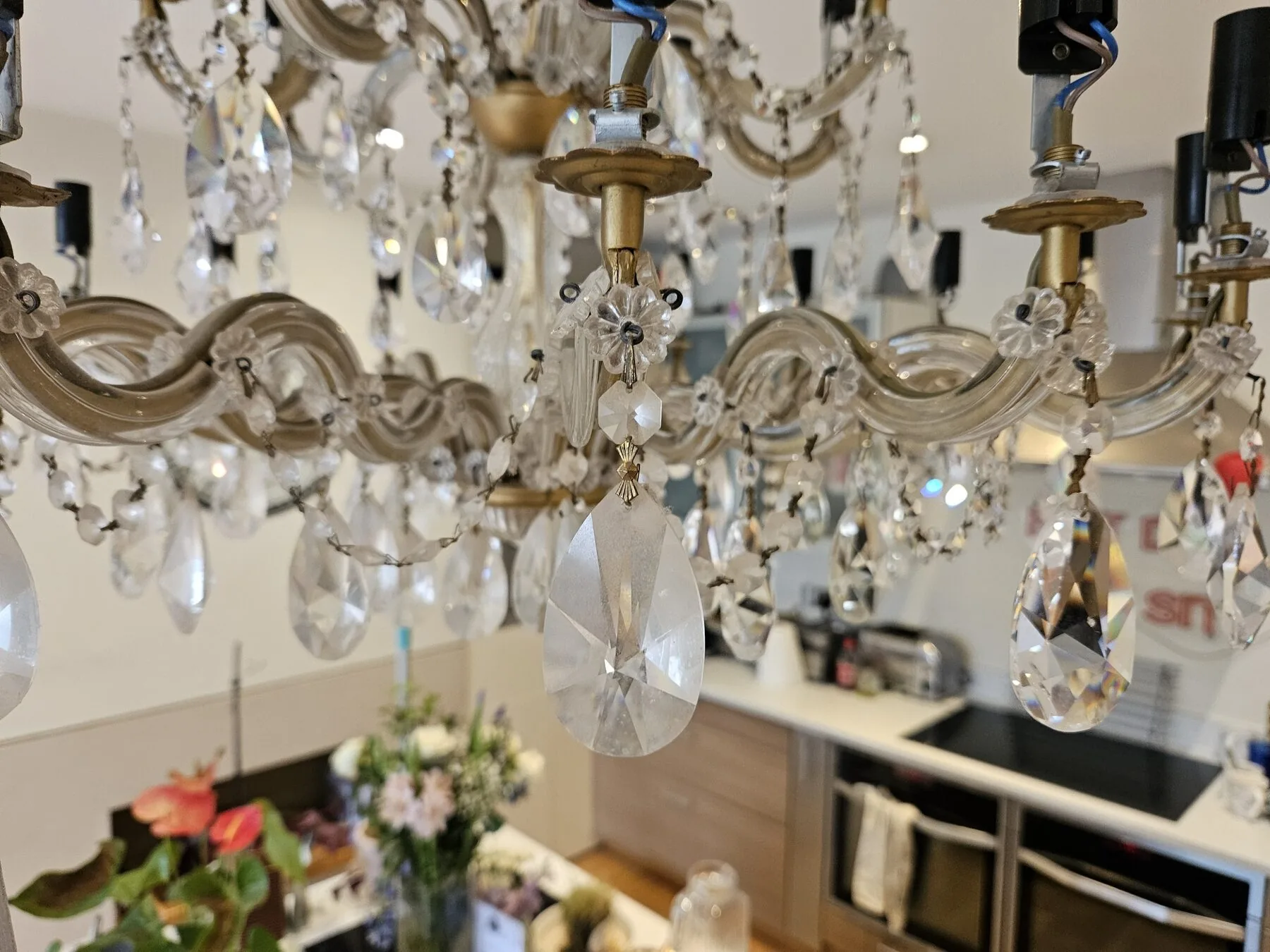 Close detail of hand-cut Strass crystal almond drops and glass rosettes on the Maria Theresa chandelier