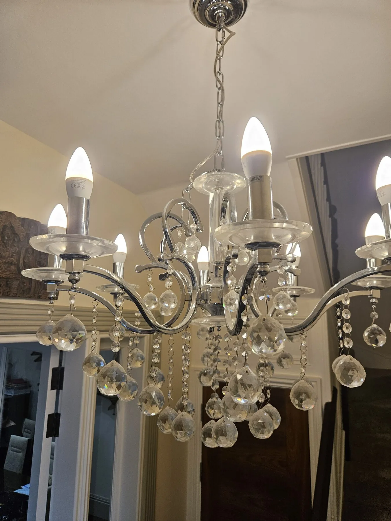 Contemporary chrome chandelier with cut crystal ball drops before cleaning