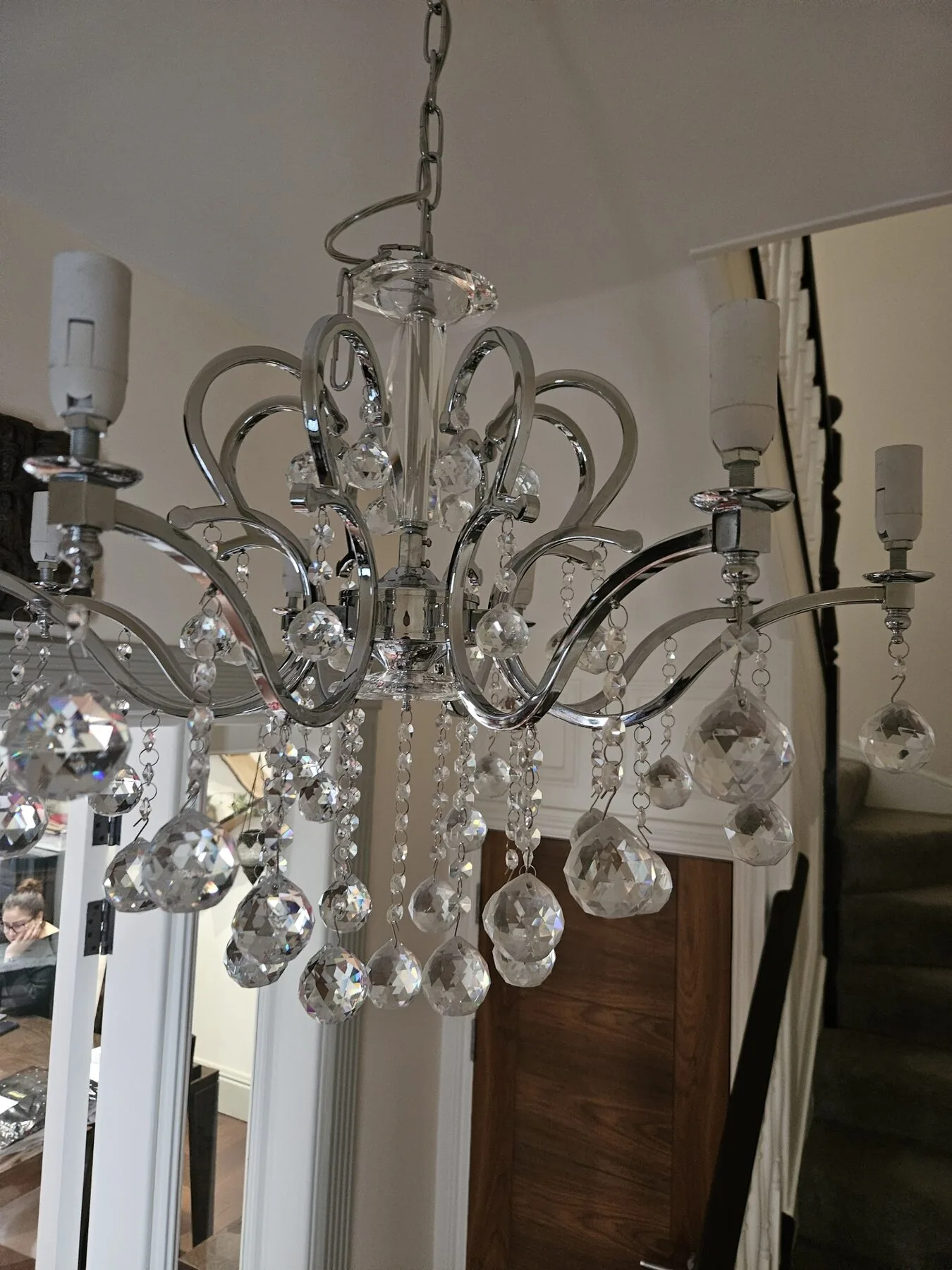 Chandelier frame and crystal drops mid-clean with lamp holders exposed