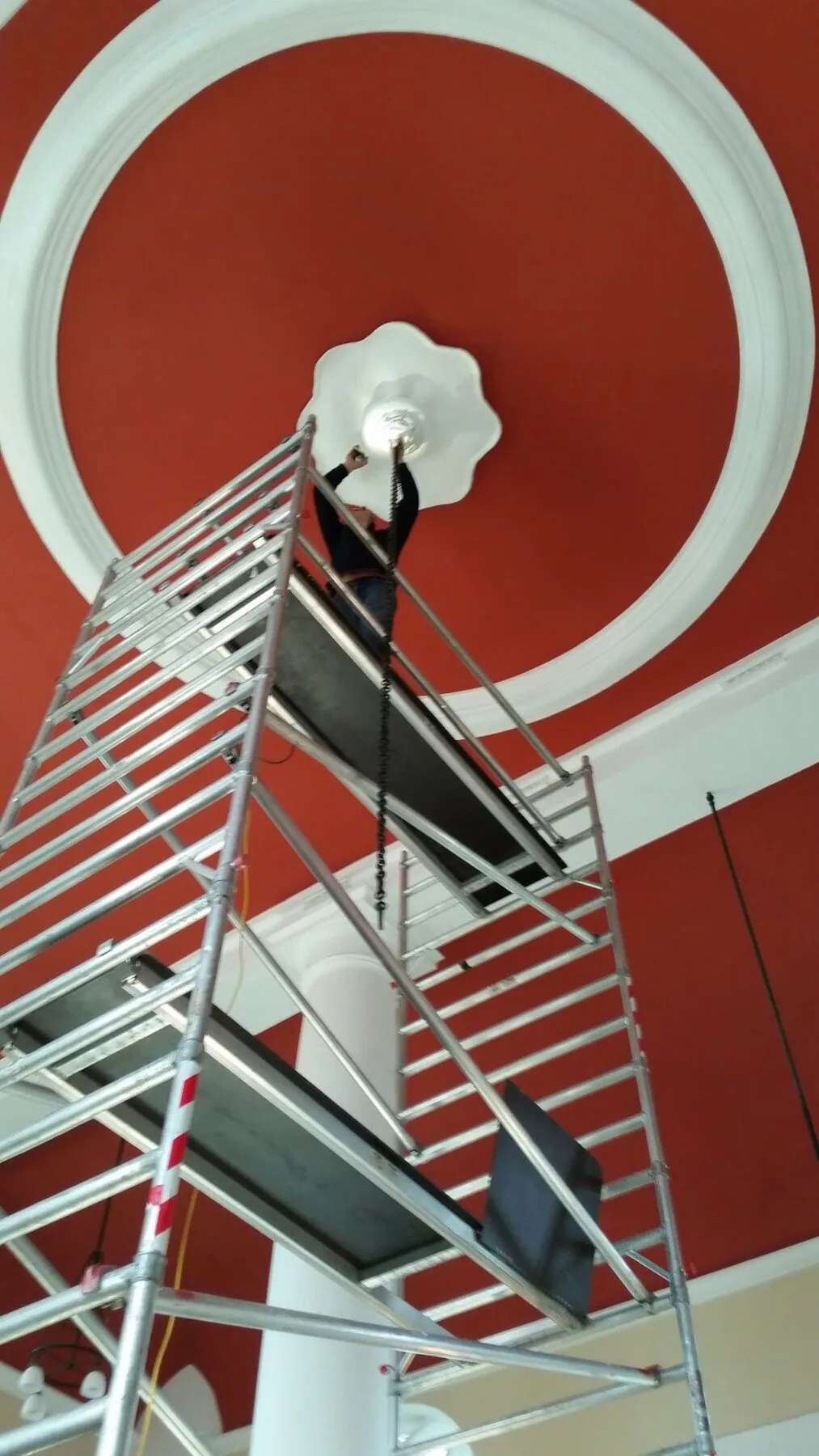 Ceiling rose and suspension chain viewed from the scaffold during removal