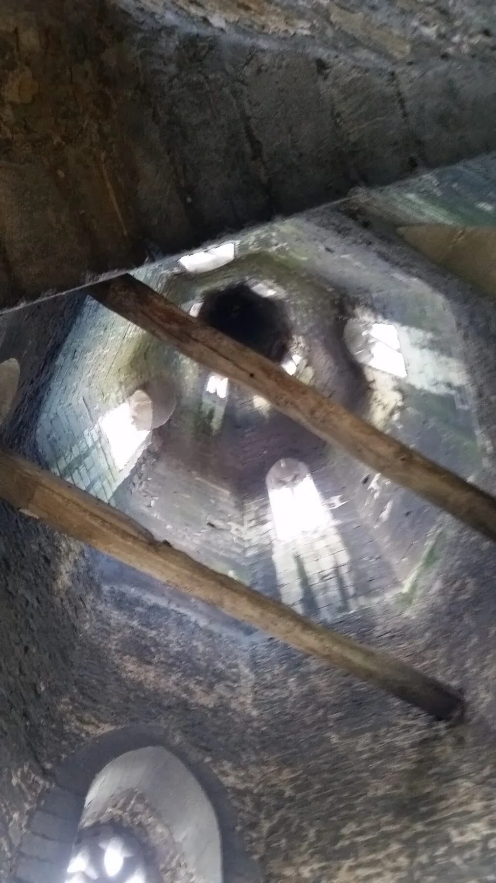 View up into the belfry showing the historic masonry above the chandelier suspension