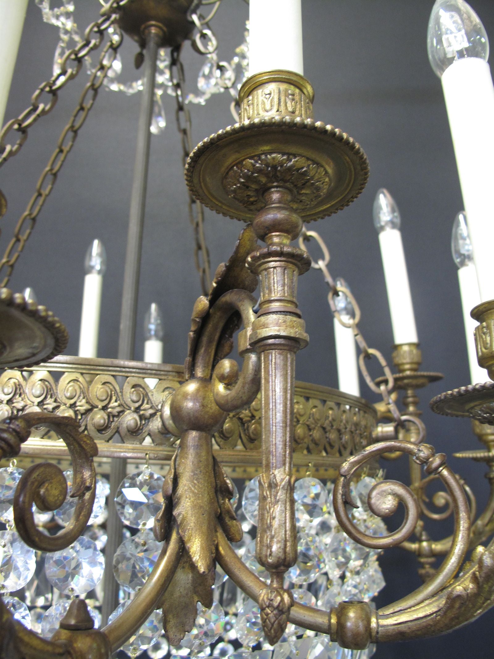 12 light ormolu and glass chandelier, showing arm casting