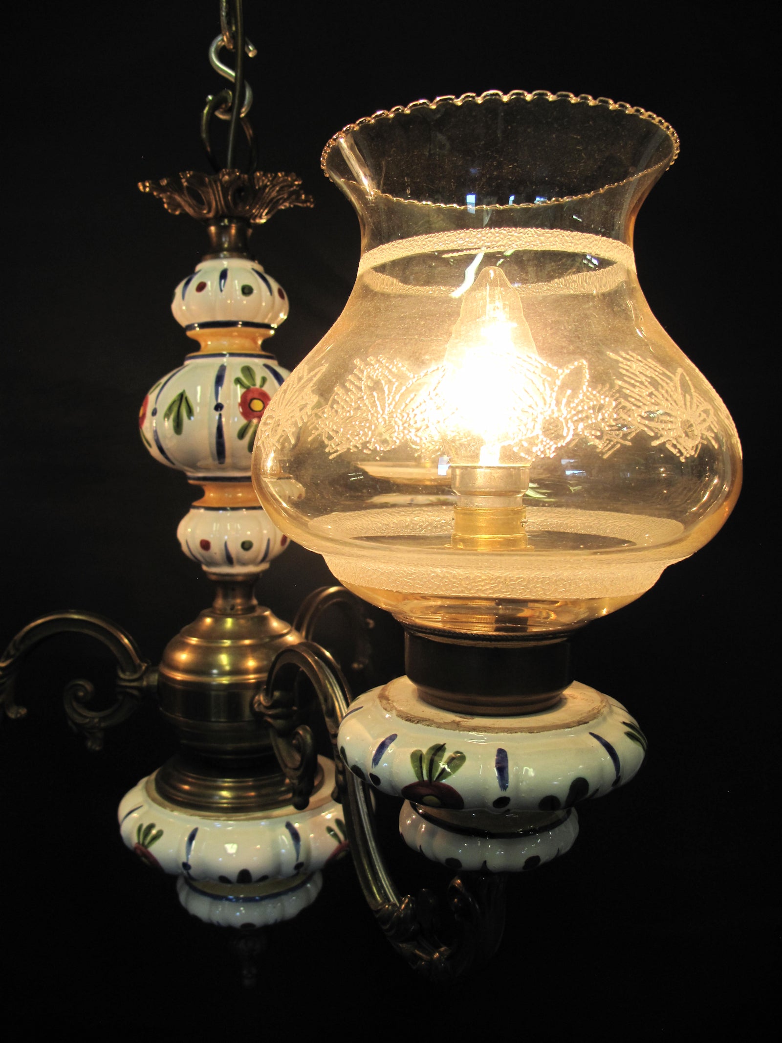 3 Arm brass & ceramic chandelier, close up of shade lit